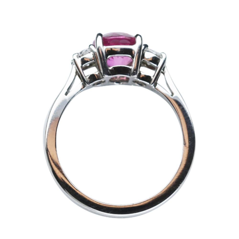 Elegant & finely detailed Solitaire Cocktail Engagement Ring, set with a securely nestled 2.21 Carat Intense Pink oval Sapphire, clarity: VS; internally flawless (IF); dimensions: 8.3mm x 6.7mm, either side set with Brilliant-cut Diamonds, measuring