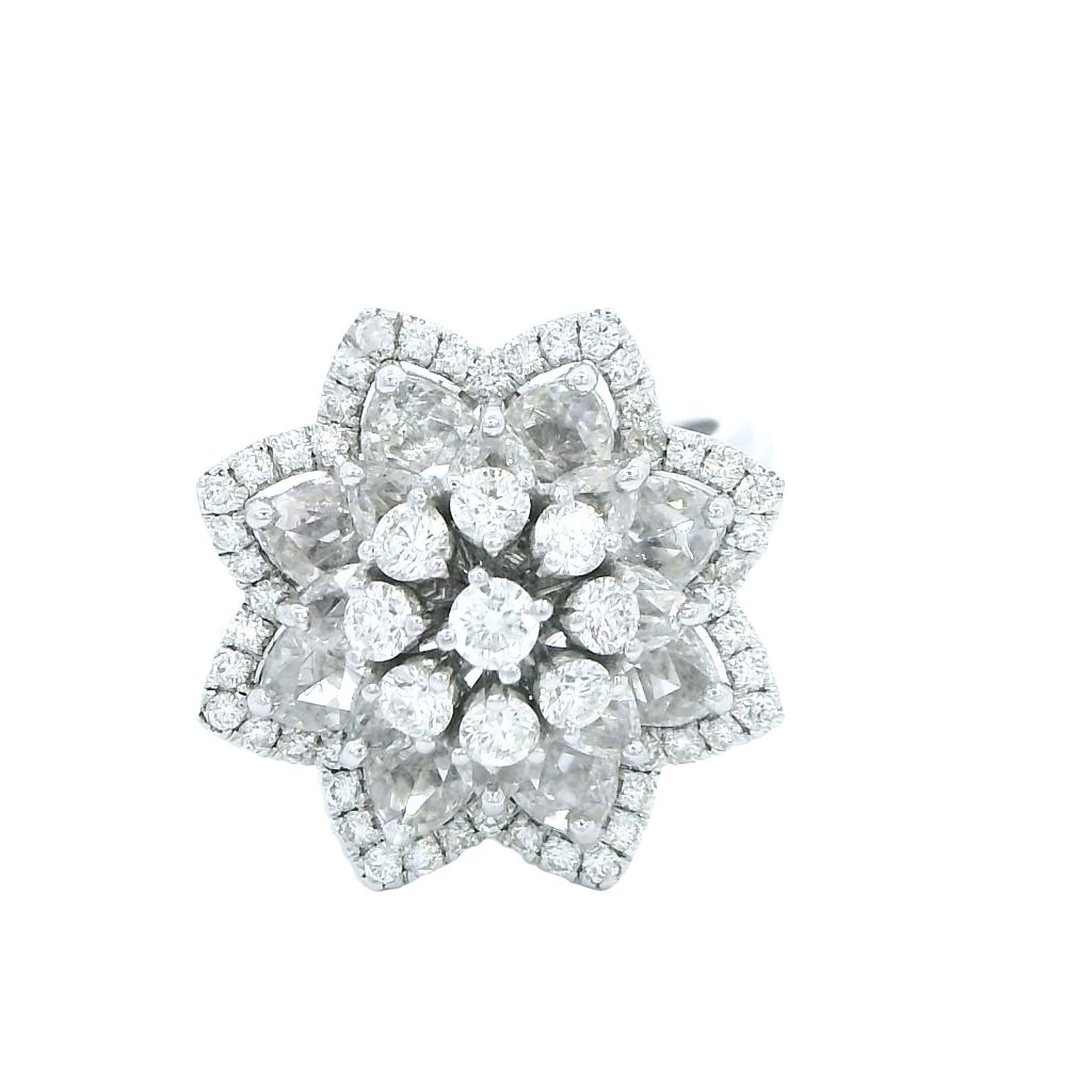 Inspired by the Lily flower, this ring has seven round brilliant cut diamonds, centered in a life like petal arrangement made from rose cut diamonds. A delicate feminine ring to define the joy of being a woman, and in the best way possible; with