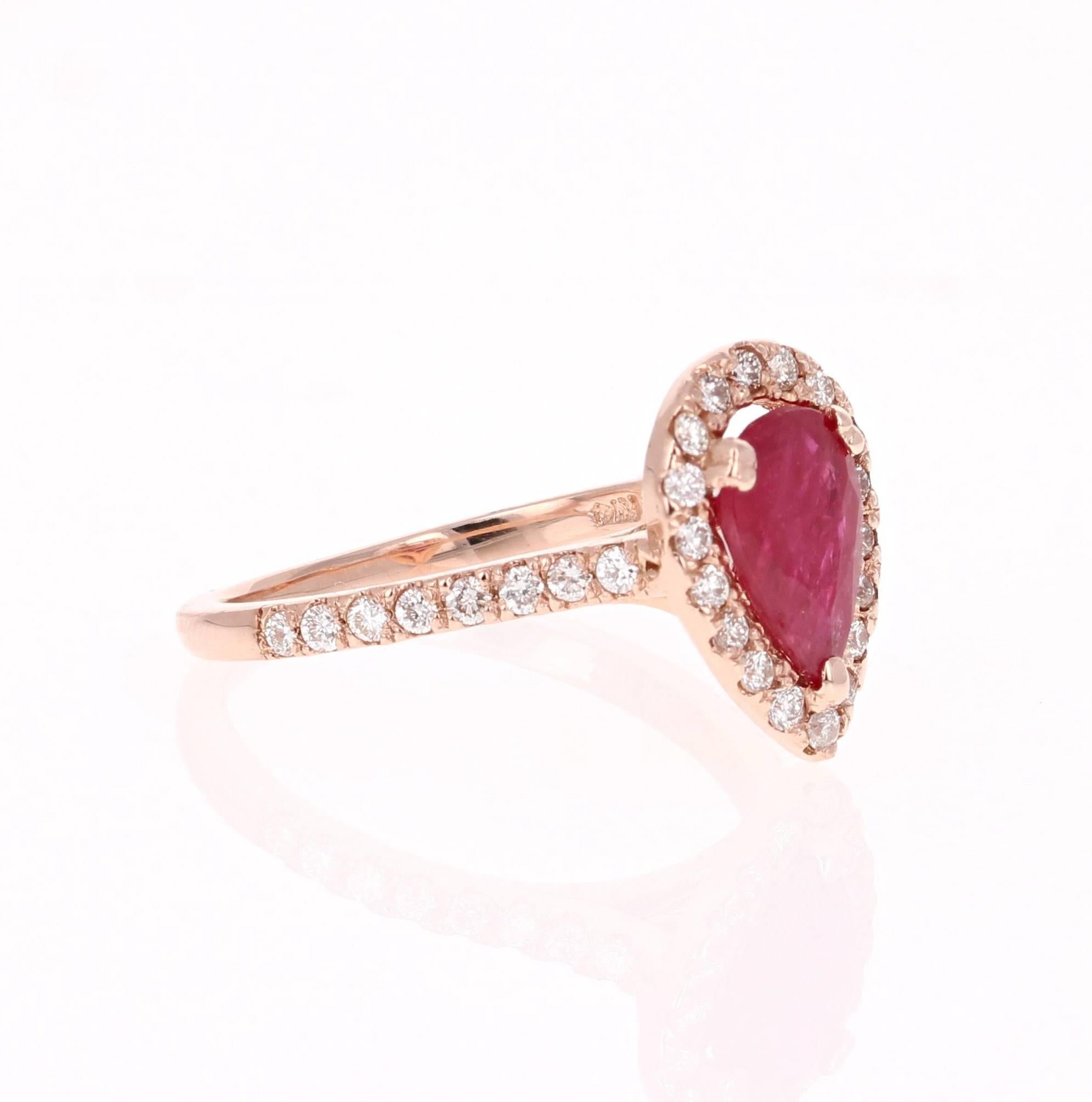 There is a Pear Cut Ruby set in the center of the ring that weighs 1.51 carats.  There are also 36 Round Cut Diamonds that weigh 0.70 carats (Clarity: VS2, Color: H).  The total carat weight of the ring is 2.21 carats.  

The ring is casted in 14K