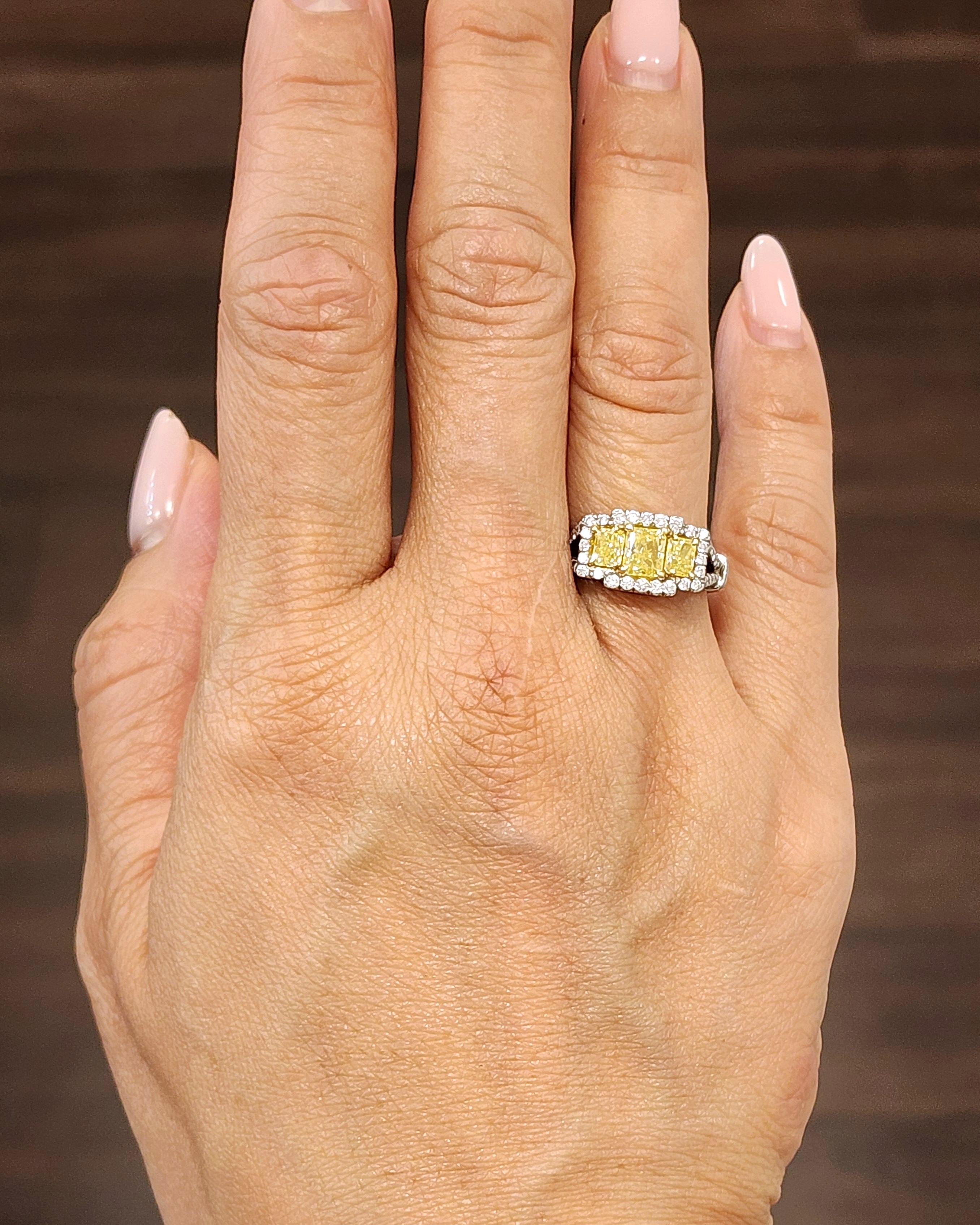This beautiful natural yellow diamond ring features a square shaped natural yellow diamond in the center weighing 0.71 ct. The two yellow diamonds on each side weigh 1.00 ct. Surrounding the yellow diamonds are 40 round cut diamonds weighing 0.50