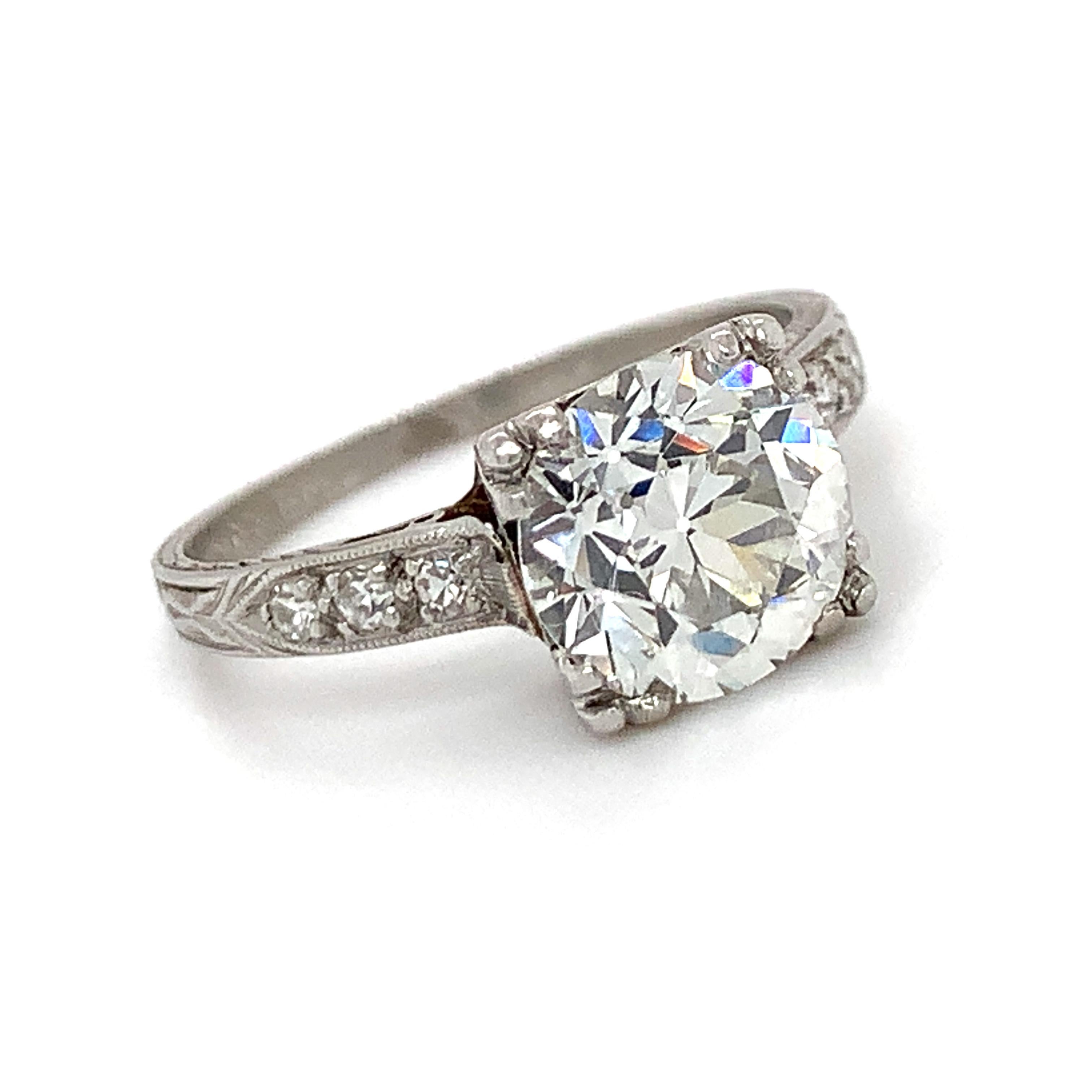 A natural 2.11 Ct old European cut diamond set in its original antique platinum ring. Appraised as VS2 clarity and H color, the 2.11 Ct center diamond is exceptionally high quality. Its fire and brilliance are simply captivating! Adorned with