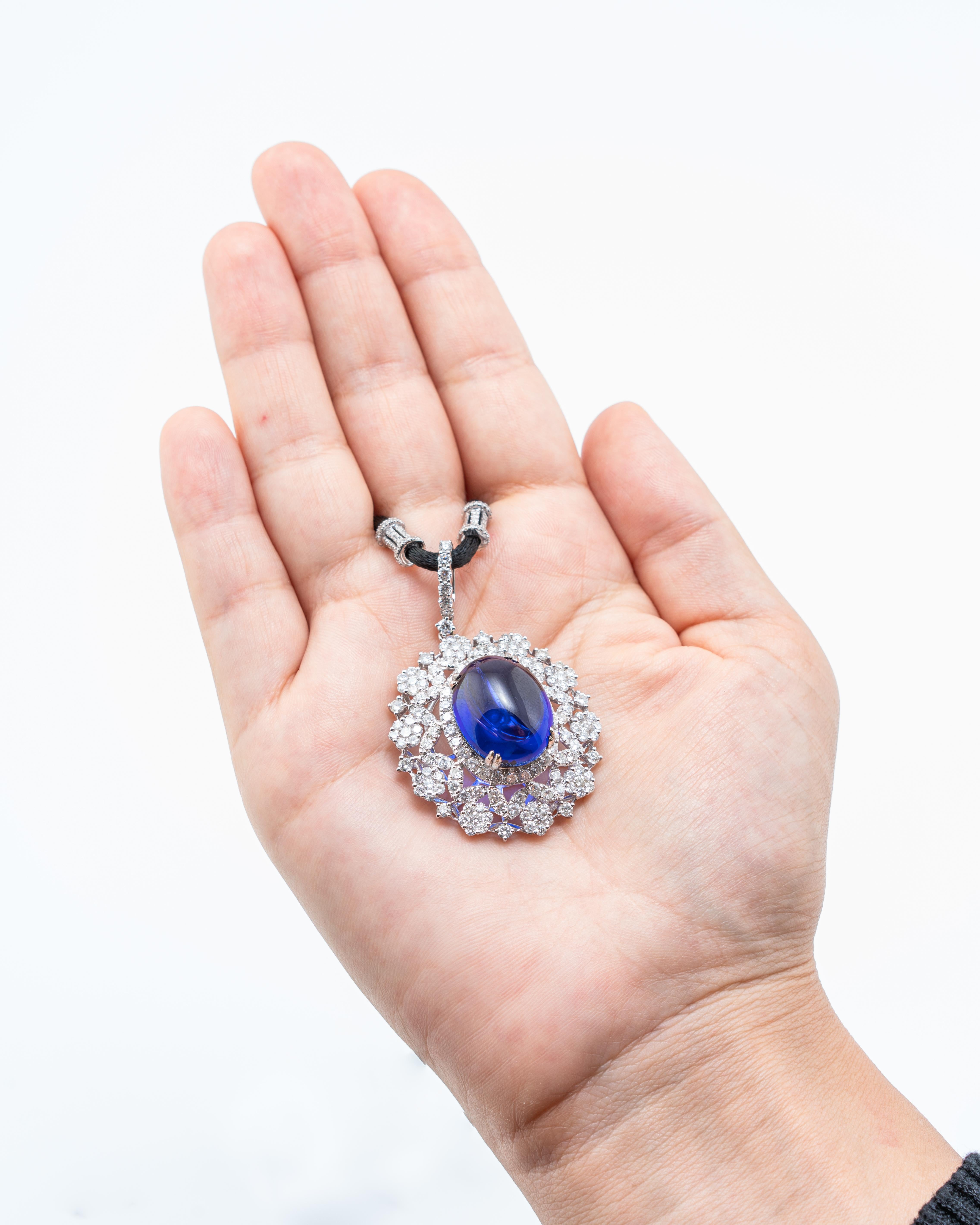 Un étonnant pendentif cabochon en tanzanite naturelle de 22,12 carats, orné de diamants - le tout serti en or blanc massif 18 carats. La pierre centrale est absolument propre, sans inclusions et d'un grand lustre. La couleur est AAAA. Une vidéo peut