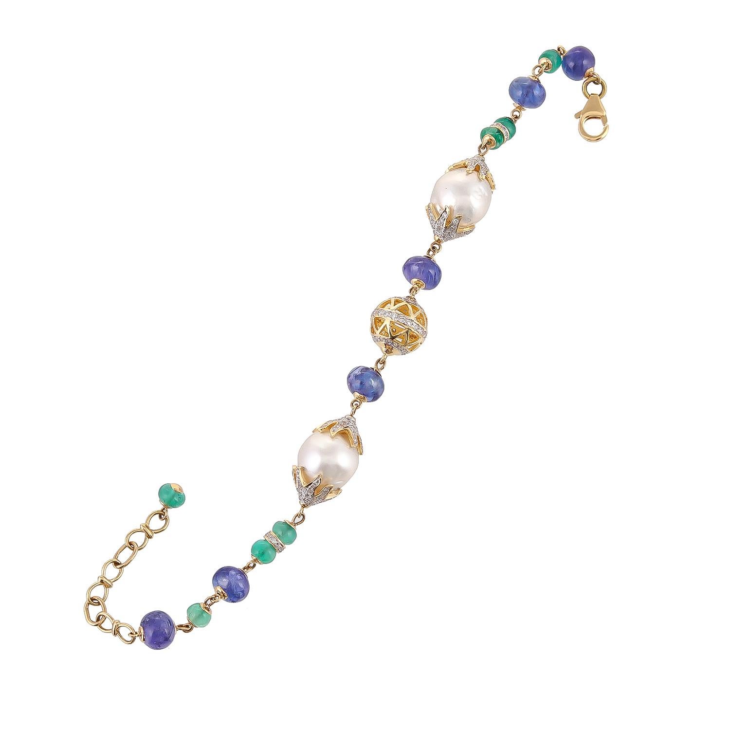 22.17 carats south sea pearl with 4.60 carats emeralds and 17.27 carats tanzanite beads make such a simple but fashionable bracelet. Decorated with 18 karats gold and diamond filigree ball with a total diamond weight of 1.30 carats, this elegant