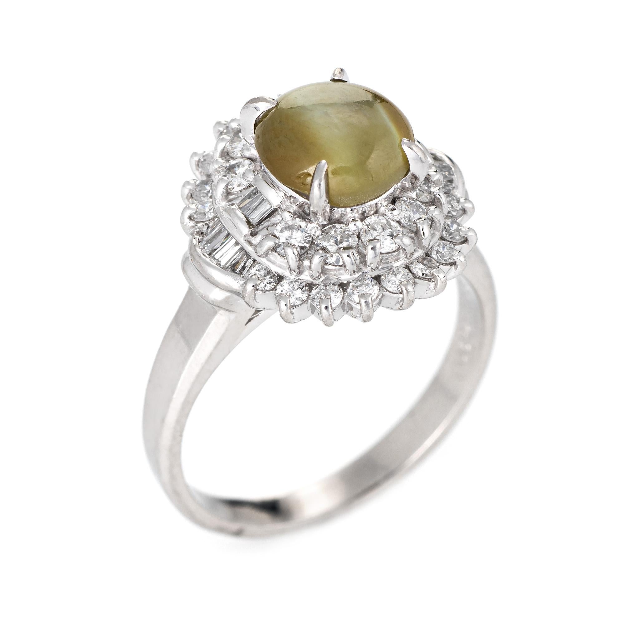 Stylish cat's eye chrysoberyl cocktail ring crafted in 900 platinum. 

Cat's eye chrysoberyl measures 8mm x 6.5mm (2.21 carats), accented with 0.73 carats of mixed cut diamonds (estimated at G-H color and SI1-2 clarity). The cat's eye is in