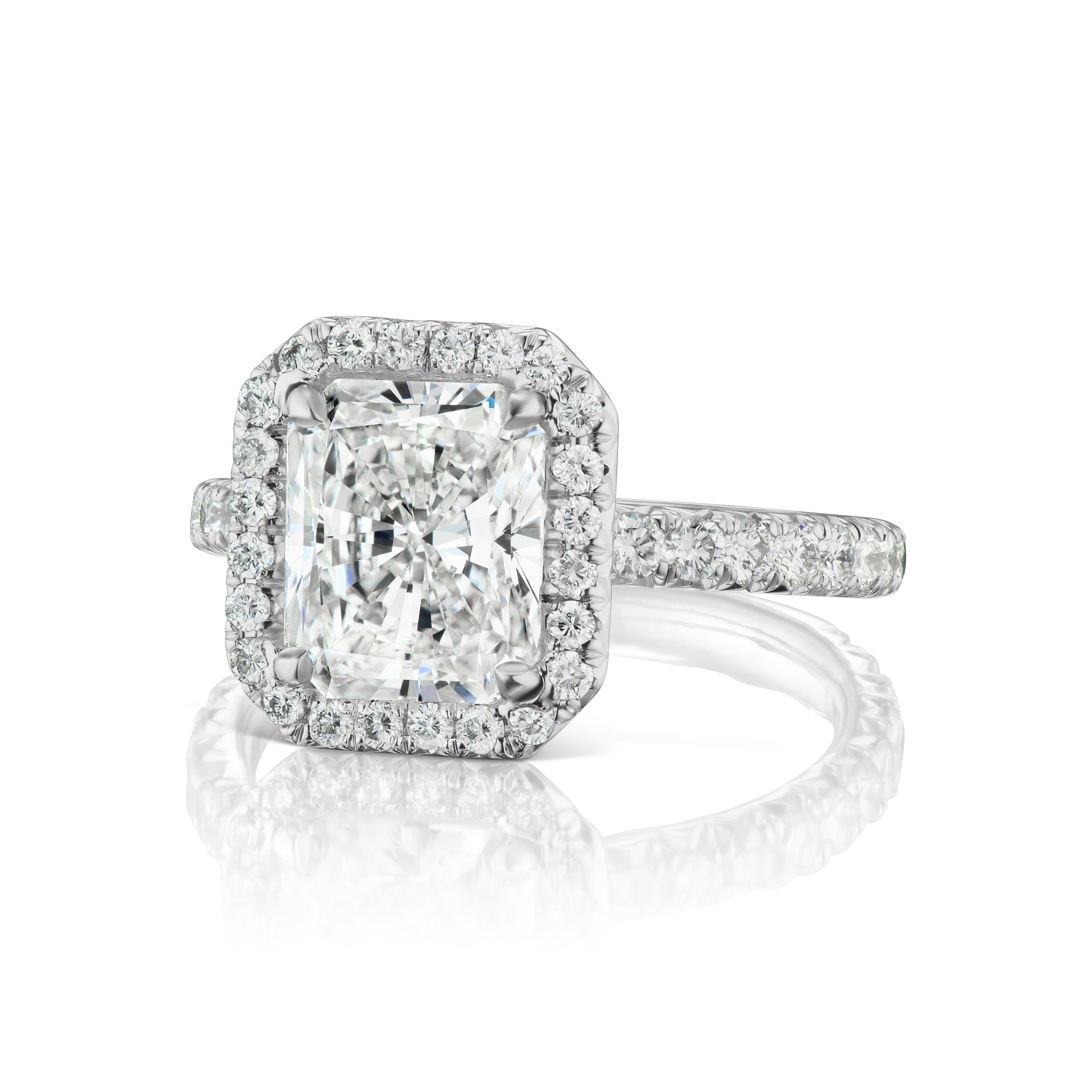 This stunning 2.21 ct. GVS2 GIA Certified Radiant Cut in set in a platinum diamond halo .48 ct. total weight of matching diamond melee enrich the center stones natural beauty.  The ring is a size 4 and can easily be resized. If you don't see