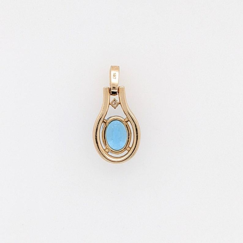 Specifications:

Item Type: Pendant
Gold Purity: 14k
Gold weight: 2.05 grams
Diamond: 32 diamonds totaling 0.31 cts

Stone Specs:
Type: Swiss Topaz
Weight: 2.21 cts
Shape: Oval
Size: 9x7mm
Treatment: Irradiated
Hardness: 8

This pendant is made with