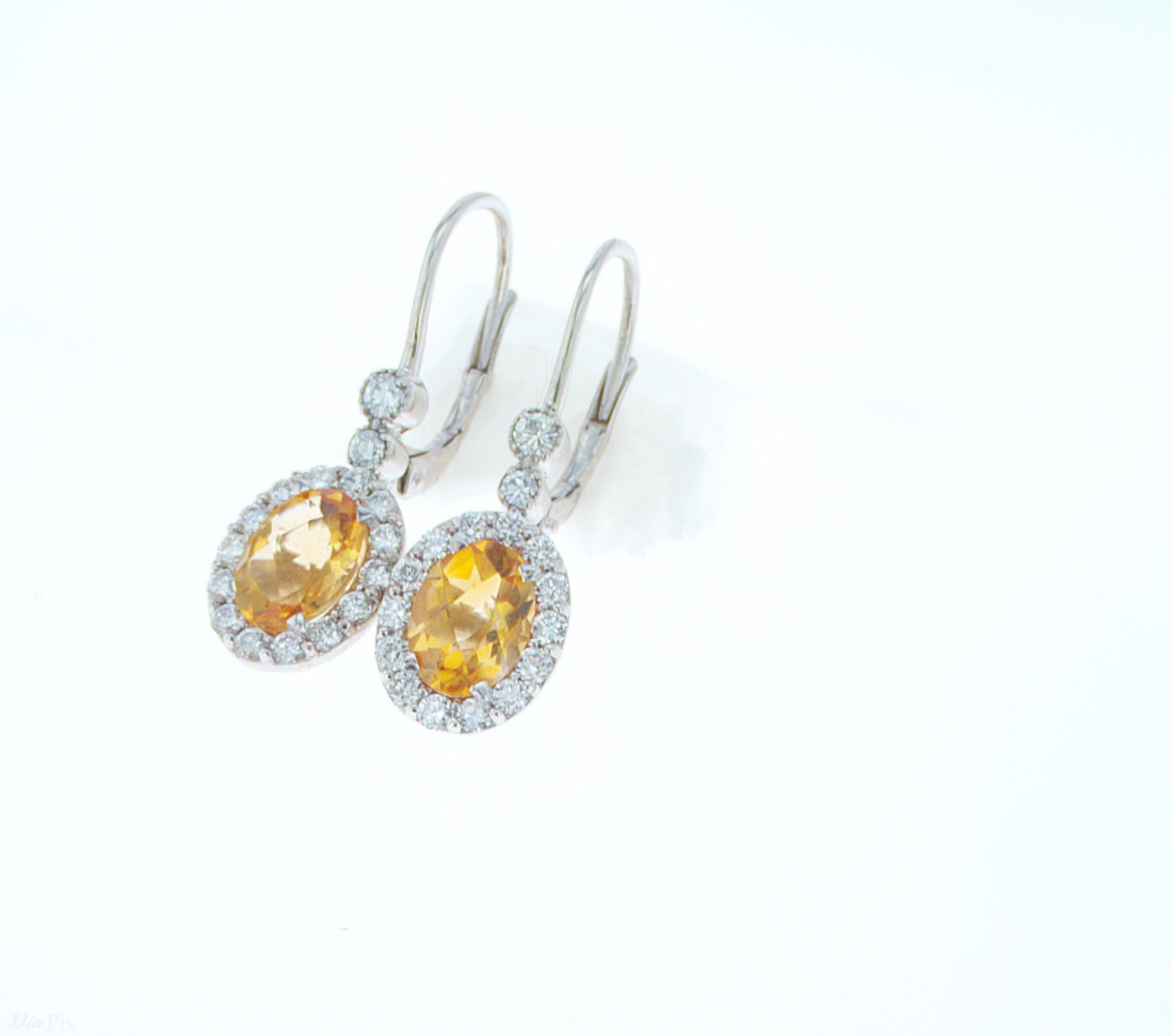 2.21ct TW Oval Citrine Earrings set in 18k White Gold, featuring 0.77ct total weight of accent Diamonds.