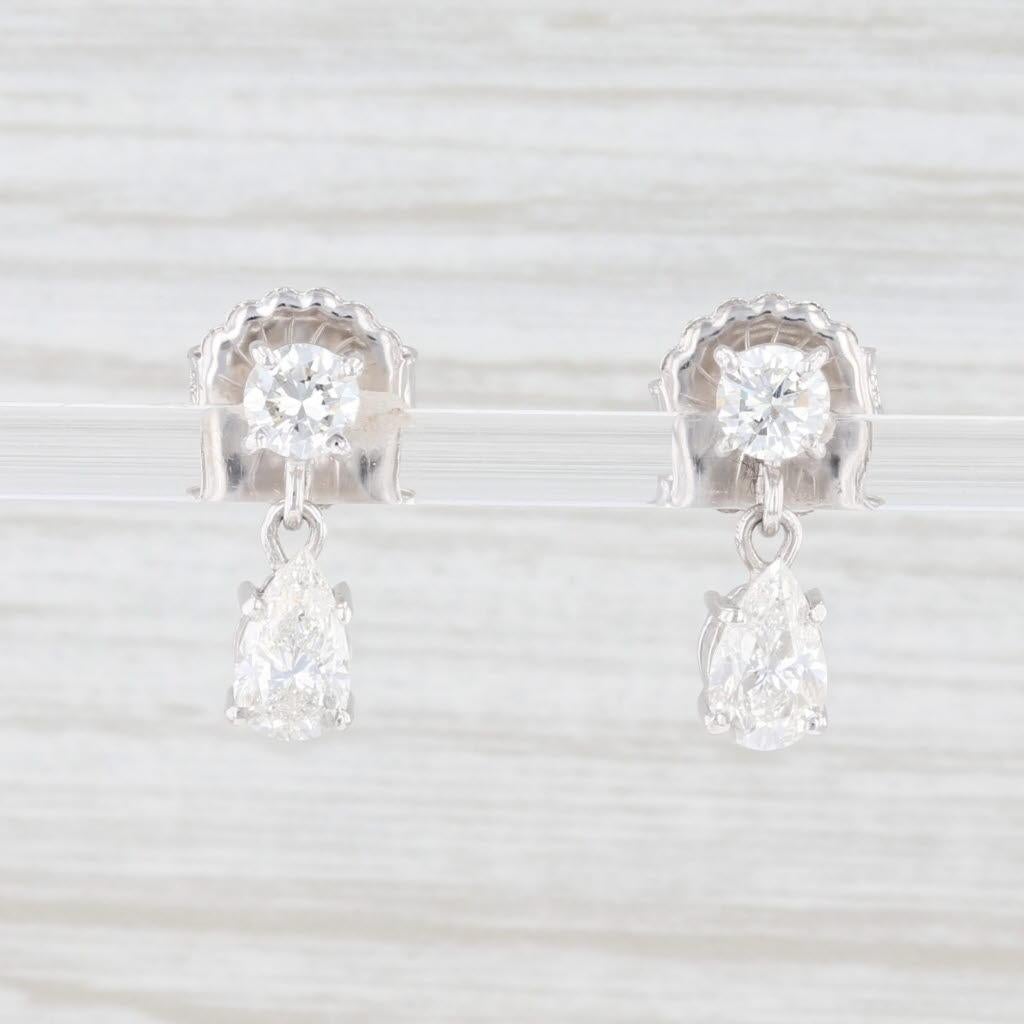 These gorgeous, classic earrings have diamond teardrops hanging from diamond set stick posts. Each round and pear cut diamond is displayed in a pronged setting with a ported back, allowing light to add a brilliant sparkle. 

Gem: Natural Diamonds -