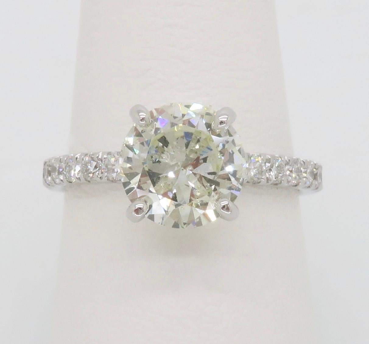 Beautiful 2.21CTW Diamond engagement ring set in 14k white gold. 

Center Diamond Carat Weight: 1.73CT
Center Diamond Cut: Round Brilliant cut 
Center Diamond Color: K
Center Diamond Clarity: I1 - Clarity Enhanced with laser drill
Accent Diamond