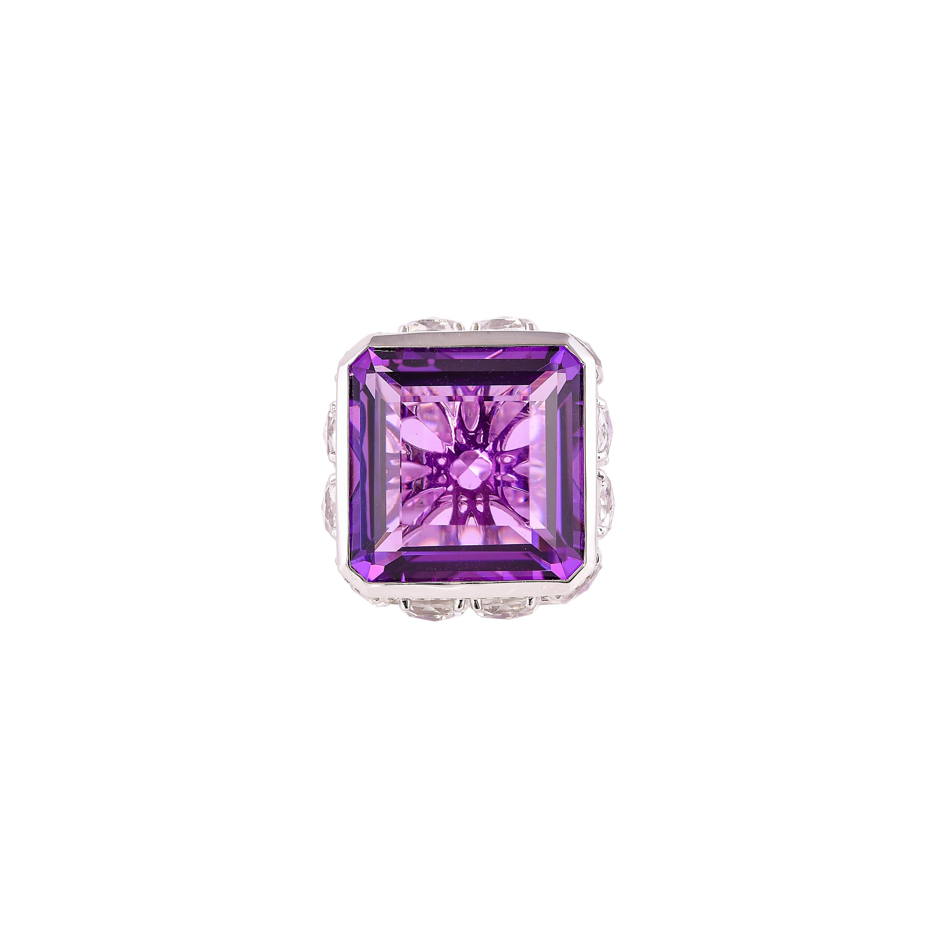 Sunita Nahata presents a stunning and regal 22 carat amethyst cocktail ring. The stunning center stone vibrantly sits on top of a cluster of diamonds and charming crystal quartz. The unique architecture to construct and combine these gemstones makes
