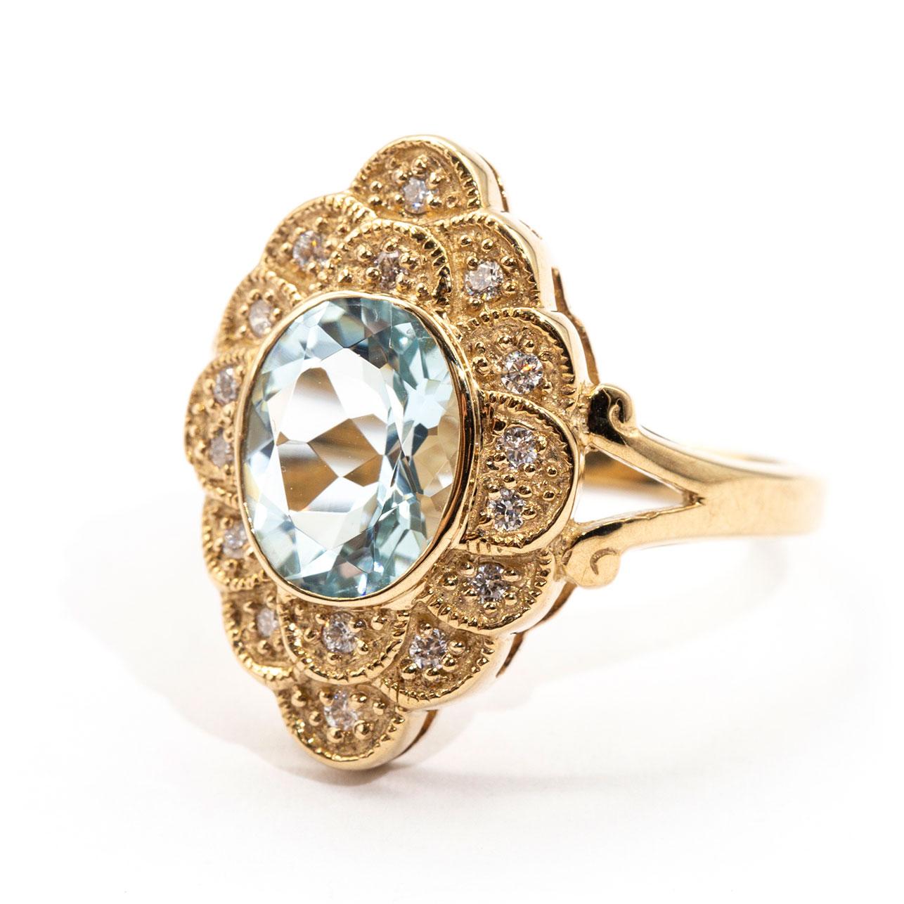 Contemporary 2.22 Carat Oval Aquamarine and Diamond Halo Cluster 9 Carat Yellow Gold Ring