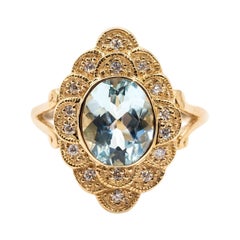 Vintage 2.22 Carat Oval Aquamarine and Diamond Halo Cluster 9 Carat Yellow Gold Ring