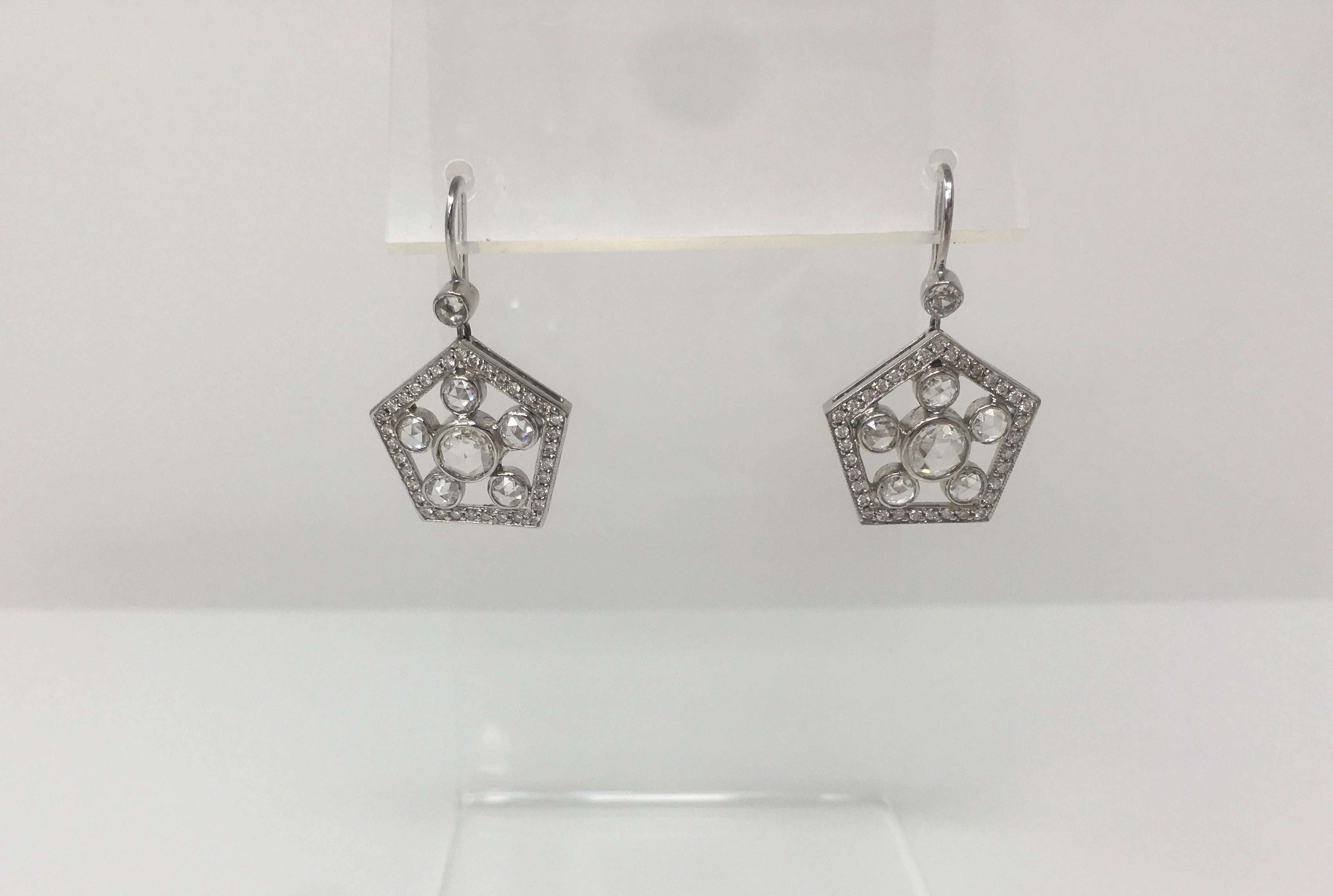 A unique pair of rose cut diamond dangle earrings are classy and wearable. These earrings  are set with a round rose cut diamond 0.60/2 in the center of the earrings with F G color and VS clarity surrounded by 5 smaller round rose cut diamond total