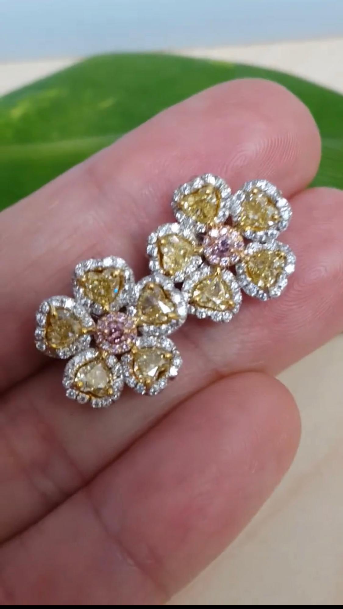 Elegant floral motifs shine in these beautiful Yellow and Pink Diamond Stud Earrings diamond. These earrings are crafted in 18k white and yellow gold feature 10 heart shape yellow diamonds weighing approximately 2.02 carat, and 20 round brilliant