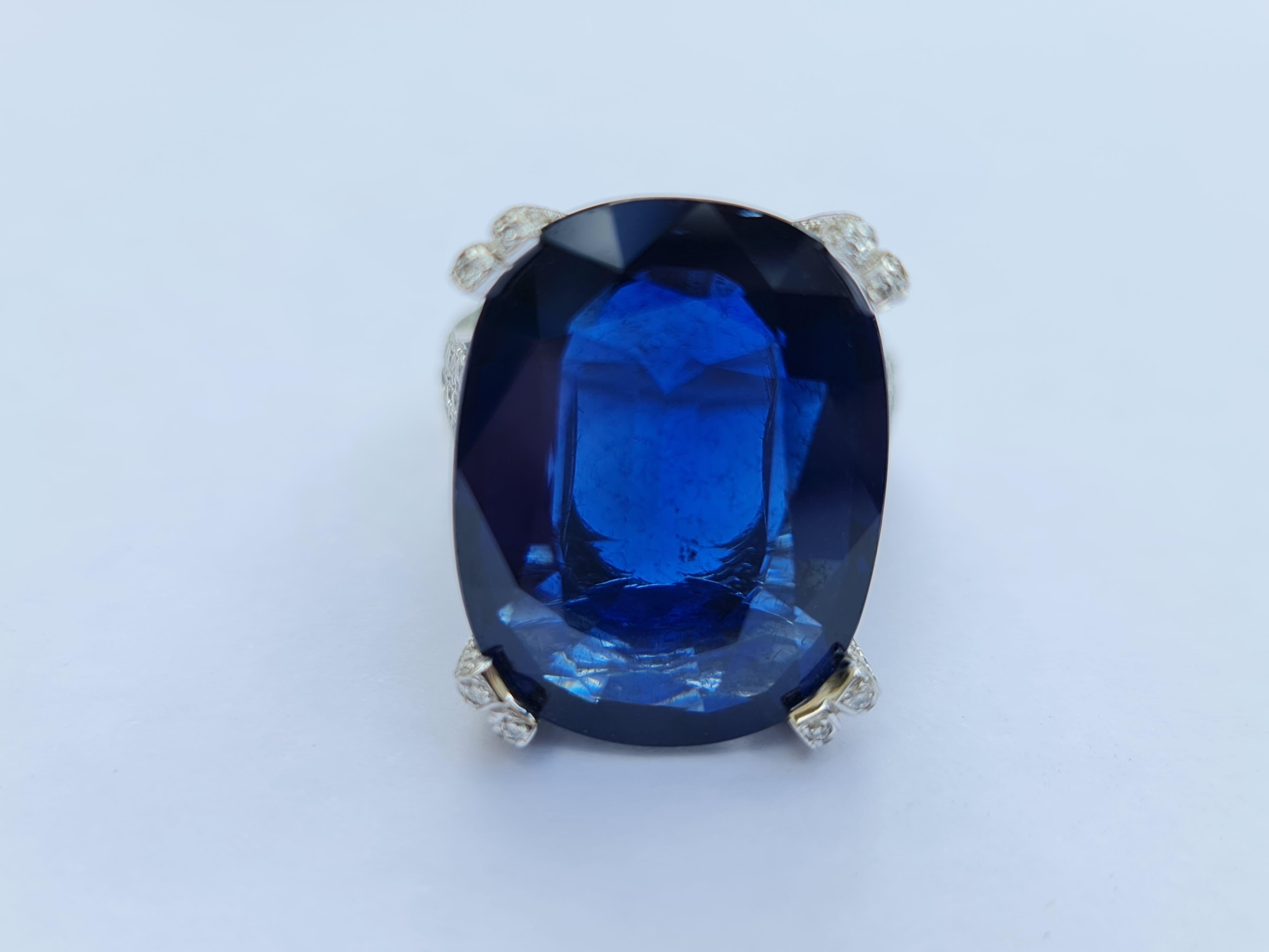 This design features 2.13 carat of VS white untreated natural diamonds, the perfect contrast to the translucent blue of this 22.22 carat natural blue Sapphire statement ring. The smooth white gold band offers a beautifully balanced texture to this