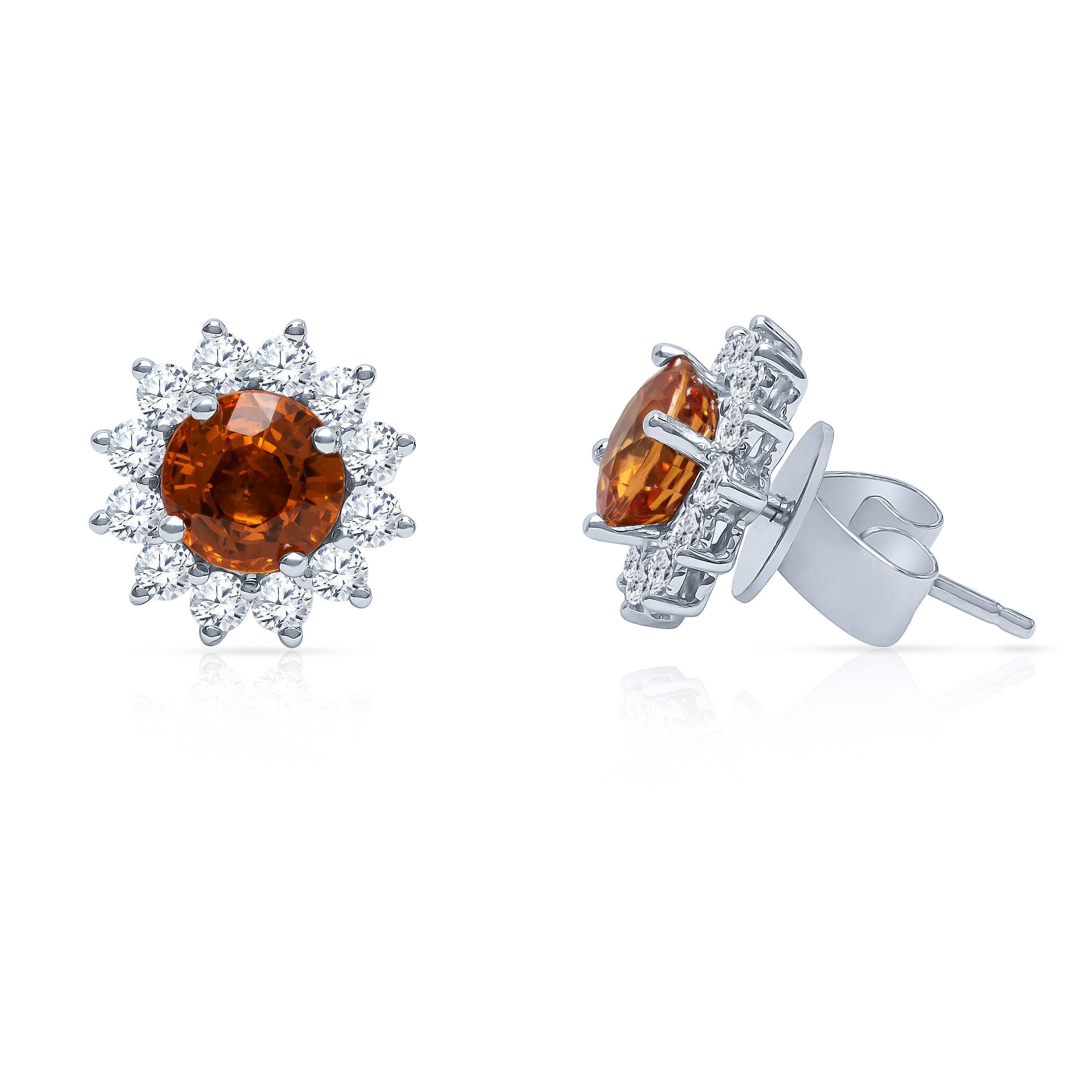 2.22 carat natural bright orange sapphire floral stud earrings with 0.73 carats in fine round brilliant diamonds set in 18K white gold. These sapphires are a rich color and would make a perfect addition to a fine jewelry collection.

Diamond