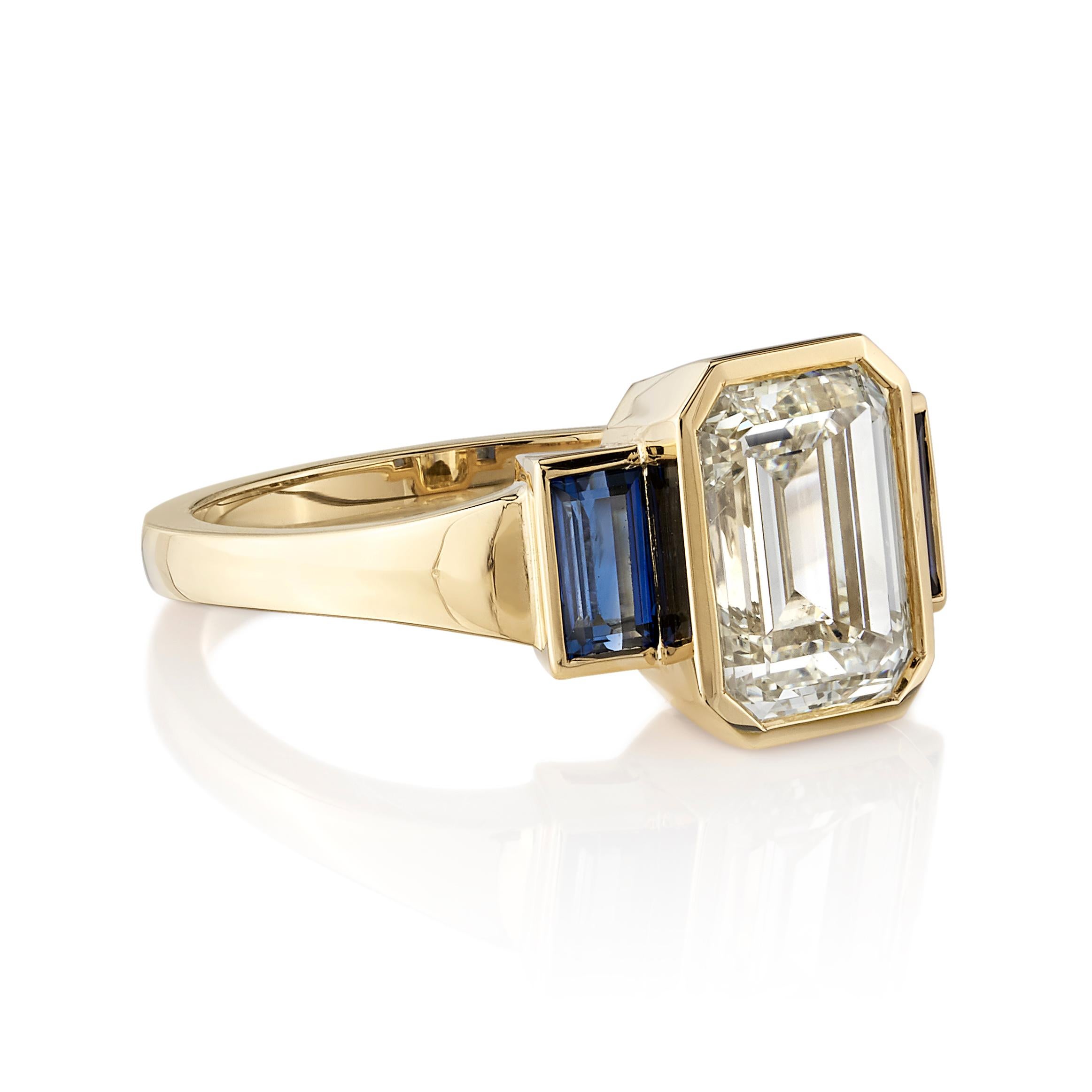 2.23ct Q-R/VS2 GIA certified emerald cut diamond with 0.50ctw baguette cut blue sapphires bezel set in a handcrafted 18K yellow gold mounting. 