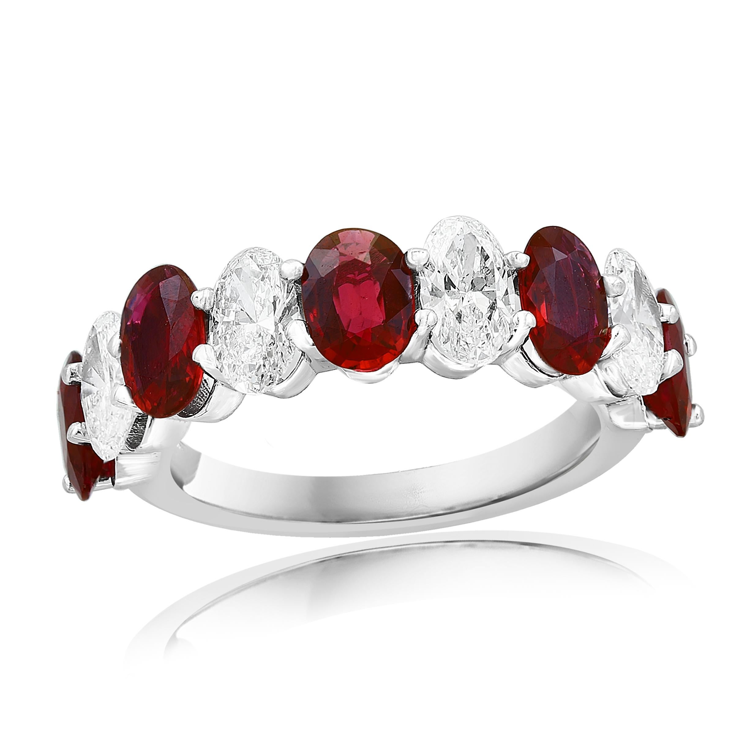 A fascinating gemstone wedding band 9 stone style showcasing 5  oval cut vivid red Rubies weighing 2.23 carats total, alternating to these red rubies are 4 oval cut brilliant colorless diamonds weighing 1.26 carats, Made in 14K White Gold, Size 6.5