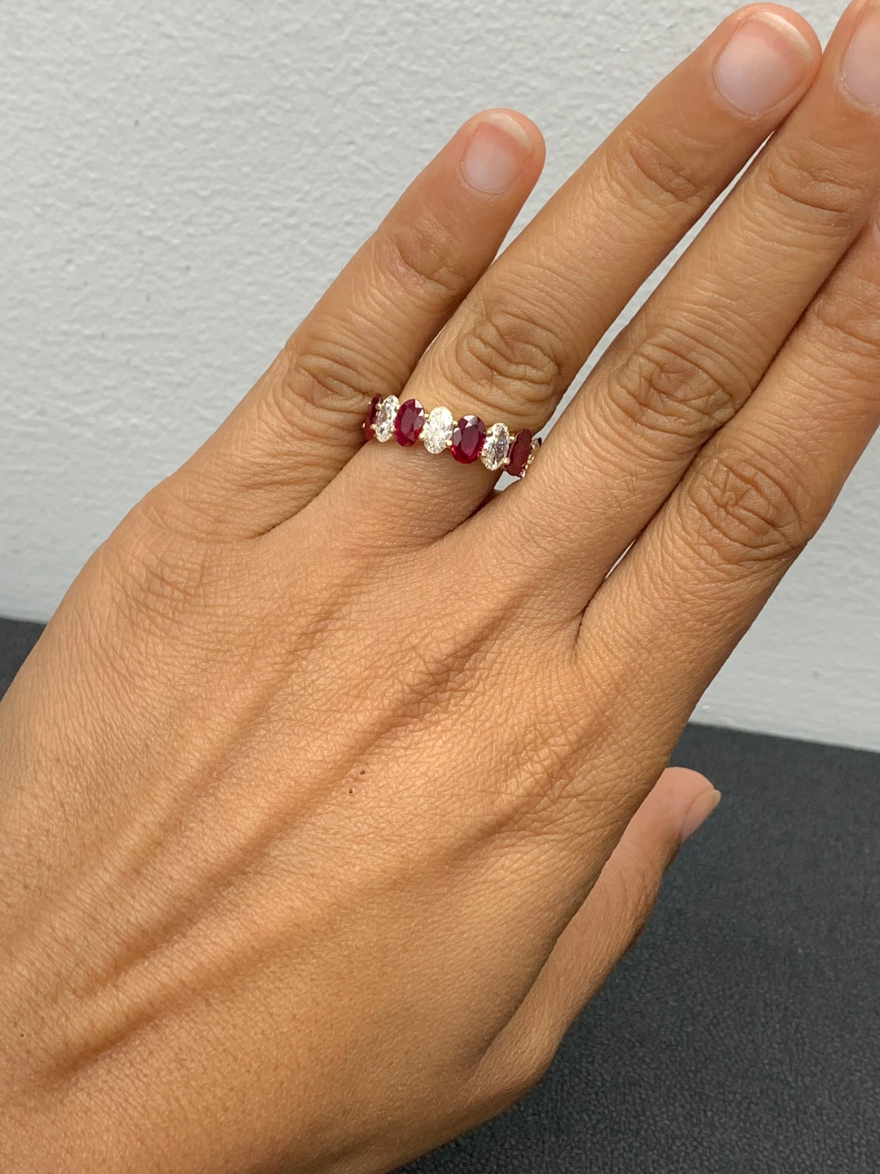A fascinating gemstone wedding band 9 stone style showcasing 5  oval cut vivid red Rubies weighing 2.23 carats total, alternating to these red rubies are 4 oval cut brilliant colorless diamonds weighing 1.26 carats, Made in 14K Yellow Gold, Size 6.5