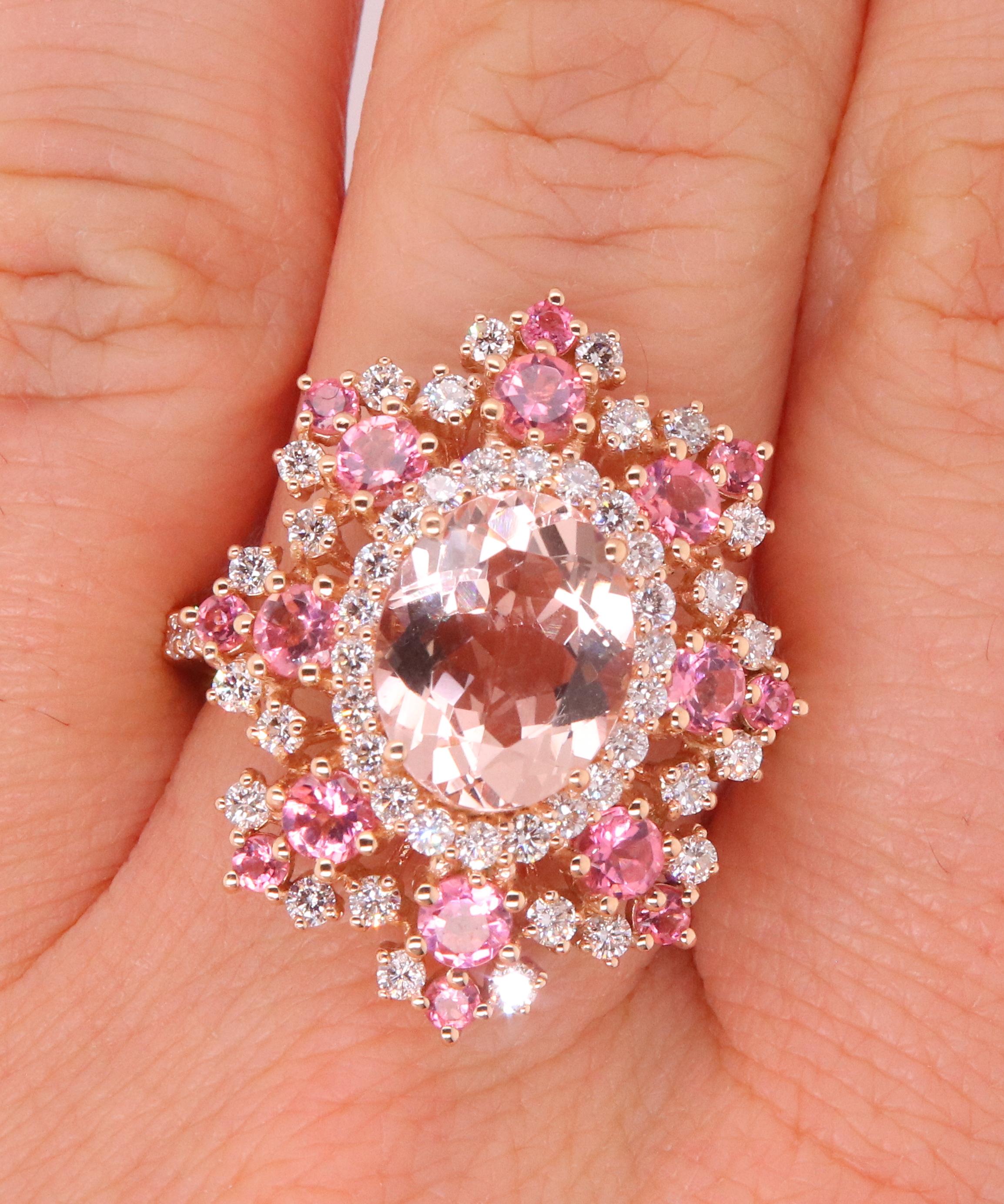 Material: 14k Rose Gold 
Center Stone Details: 1 Oval Pink Morganite at 2.23 Carats - Measuring 10 x 8 mm
Mounting Stone Details: 16 Round Pink Tourmalines at 1.08 Carats
Diamond Details: 54 Brilliant Round White Diamonds at 0.77 Carats - Clarity: