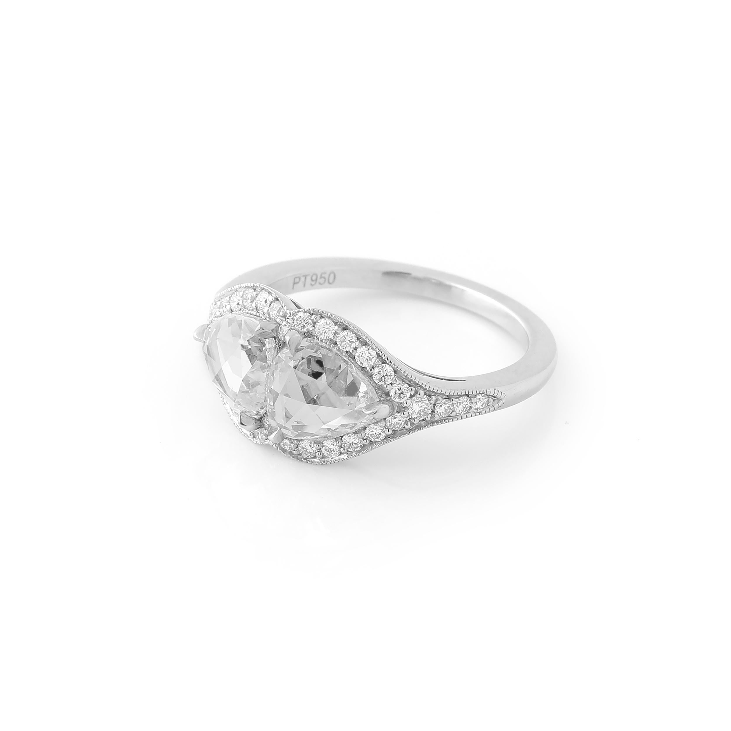 This twin stone or 'Toi et Moi' ring features a beautifully matched pair of rose cut pear shape diamonds weighing 2.23 carats total. The diamonds 100% natural and approximately F to G color and VS clarity. The stones are set in a beautiful platinum