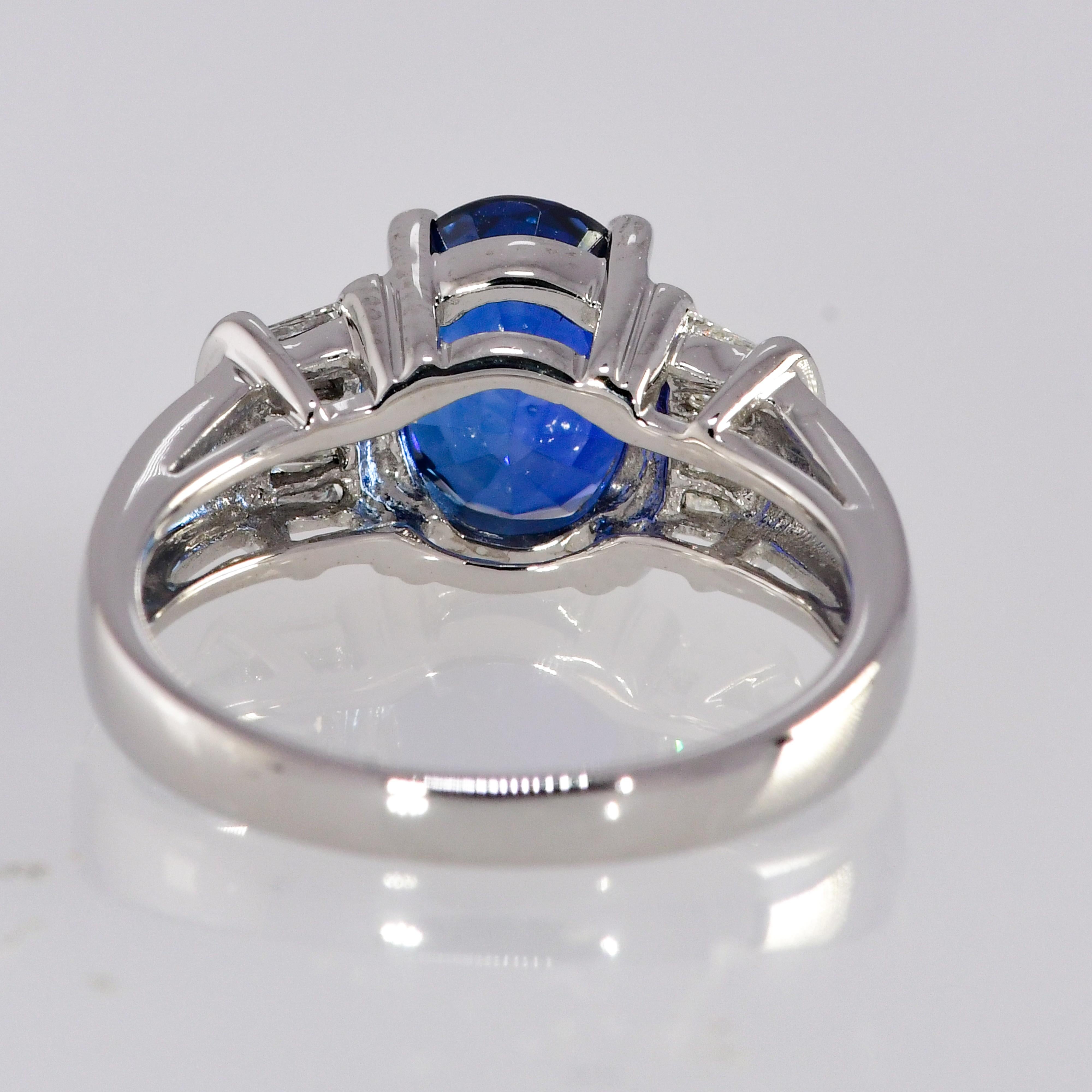 This classic elegant ring contains a deep vibrant diffused blue sapphire ring weighing 2.23 carat with no eye visible inclusions. The sapphire is flanked by 10 baguette diamonds totaling .25 carat. The diamond quality is SI1; G-H. The weight of the