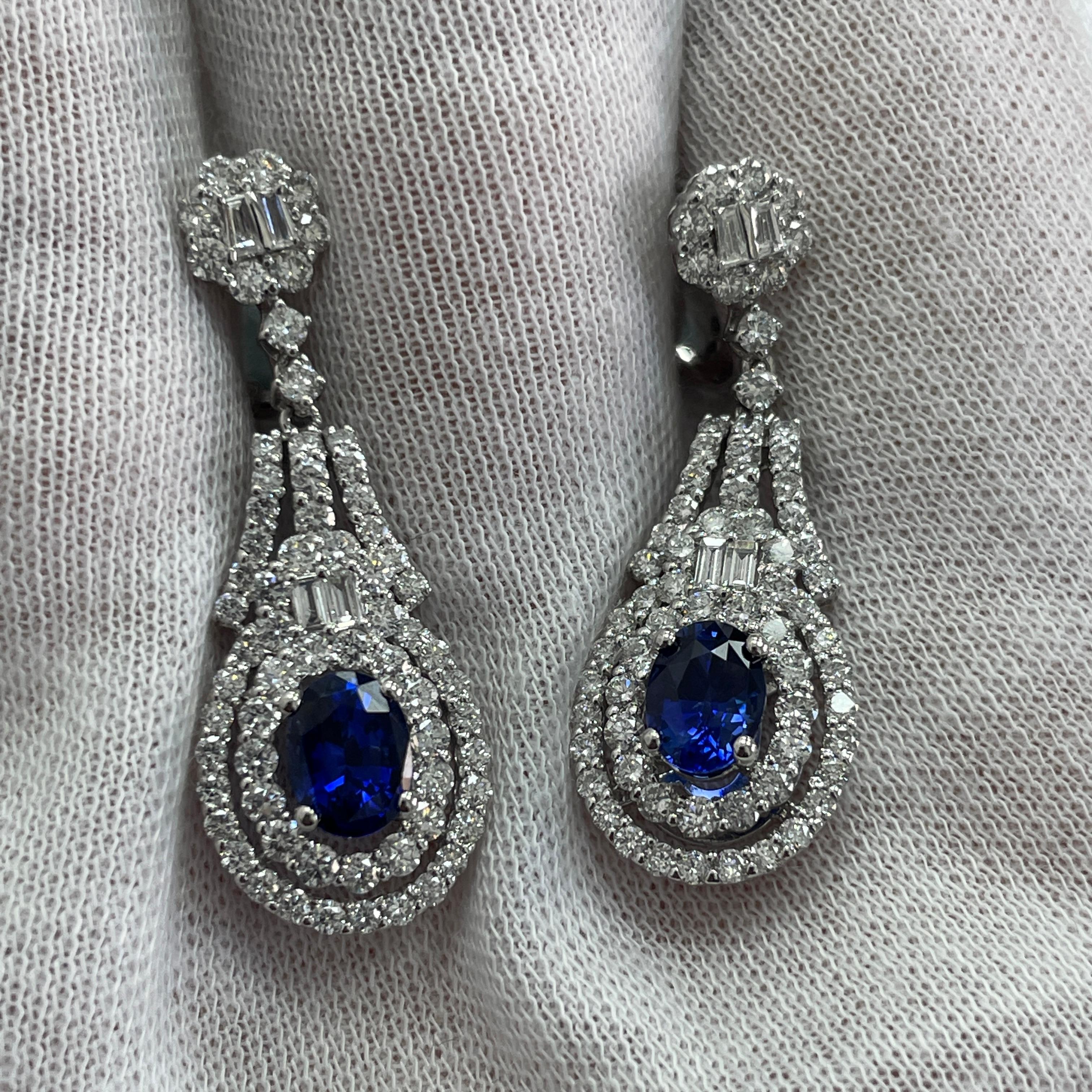 These dangling 18K white gold earrings carry 2.61Ct of brilliant white diamonds and 2.23Ct of stunning matching sapphires
