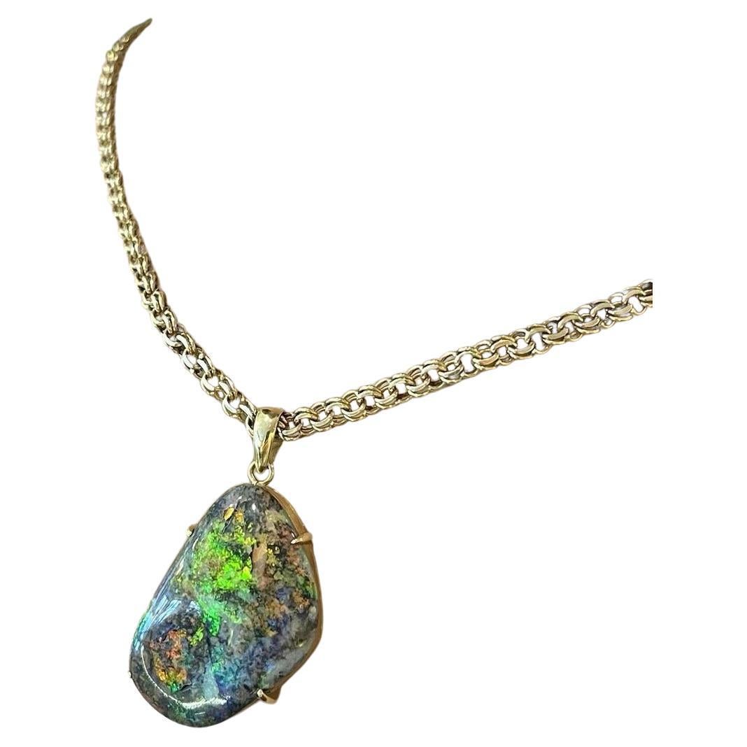 22.31 ct Boulder Opal Pendant Necklace in 18k & 14k Yellow Gold

Boulder Opal Pendant Necklace features a Natural Boulder Opal weighing 22.31 carats with Orange, Purple, and Green Play-of-Color, all set in 18 Yellow Golds on a 14k Yellow Gold Double