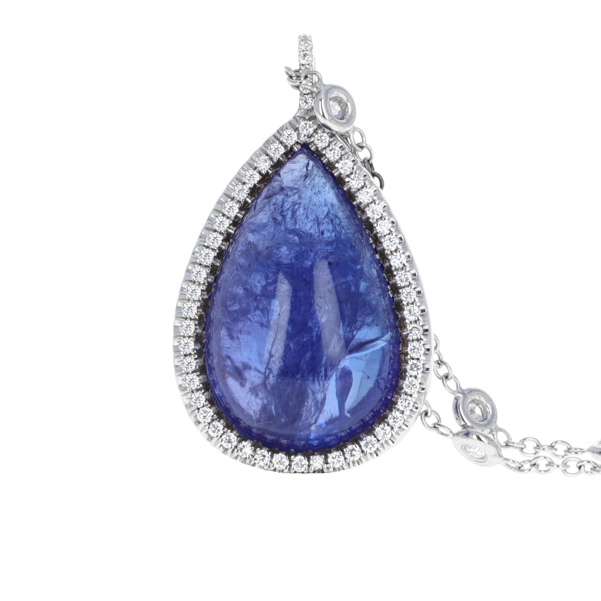  Stylish 22.32 carat pear shape Tanzanite pendant with diamond by the yard chain necklace. The Tanzanite is a cabochon. A cabachon is a gemstone which has been shaped and polished, opposed to being faceted. The pendant has diamond pave around it.