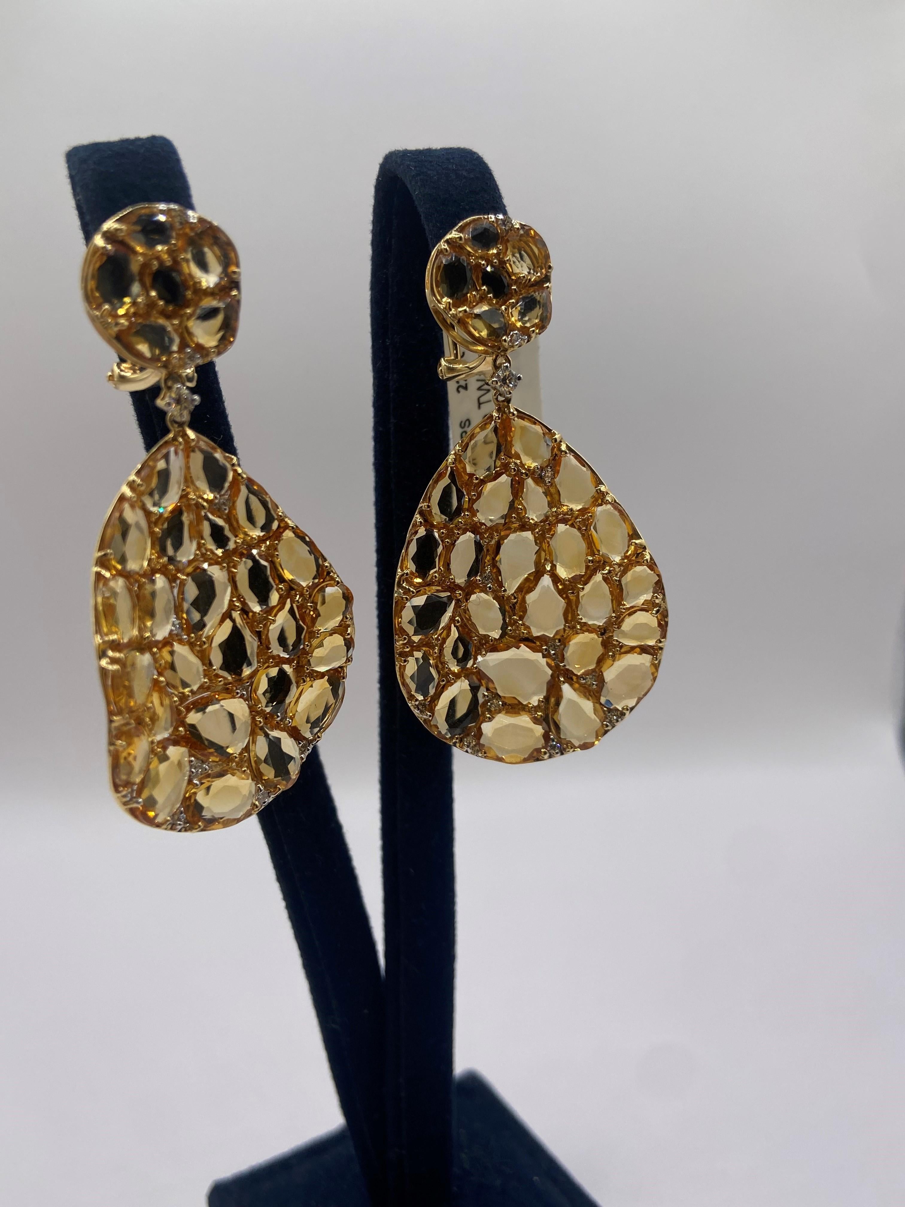 • 18KT Yellow Gold
• 22.32 Carats

• 24 Round Diamonds: 0.22ctw
• Color: F
• Clarity SI1

• Number of Rose Cut Citrines: 62
• Carat Weight: 22.10ctw

This pair of earrings is made with 62 rose cut yellow citrine stones, weighing 22.10 carats. The