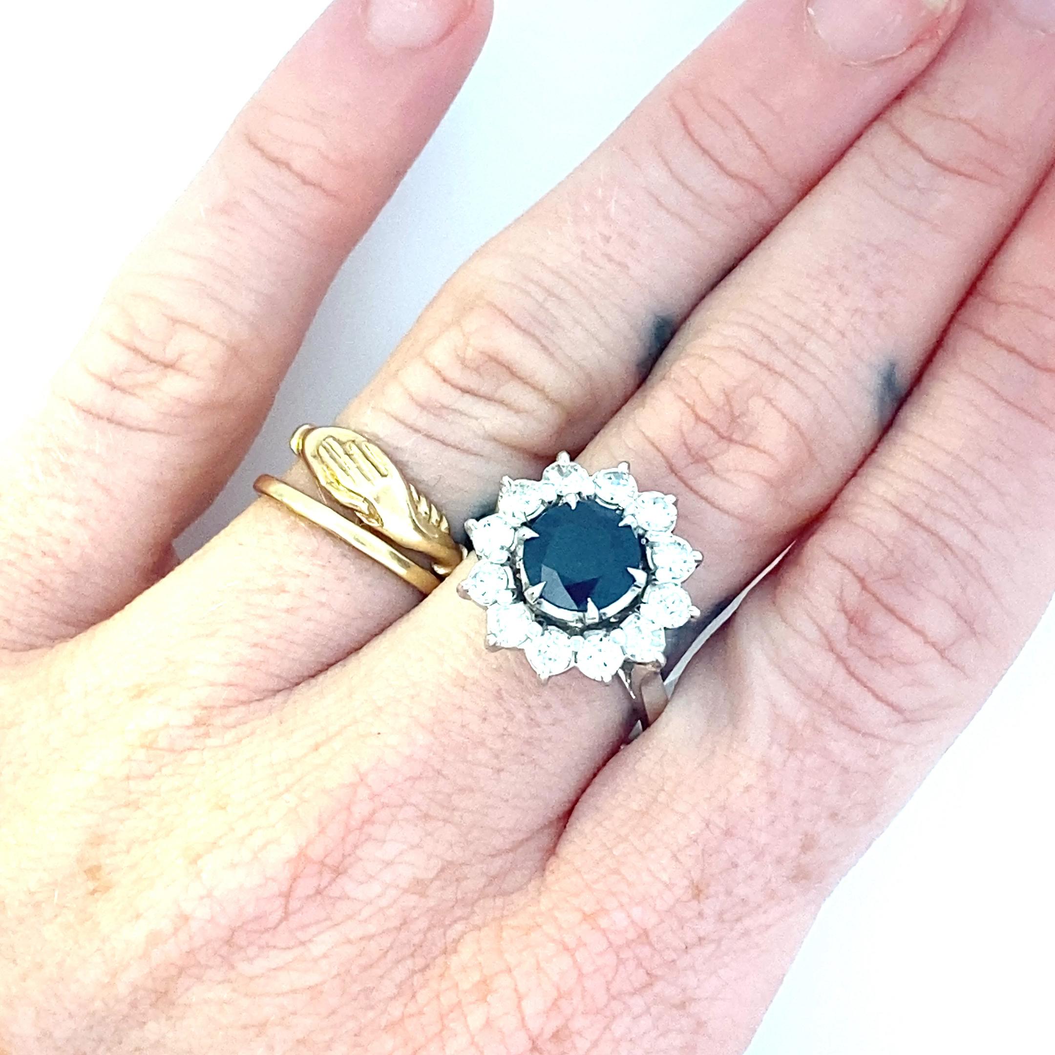 This is an incredible cocktail ring featuring a deep dark blue heat treated ceylon sapphire measuring approximately 8mm in diameter, weighing in at 2.23 carats. Set high above a 2mm band this ring also features a gorgeous diamond halo, more than