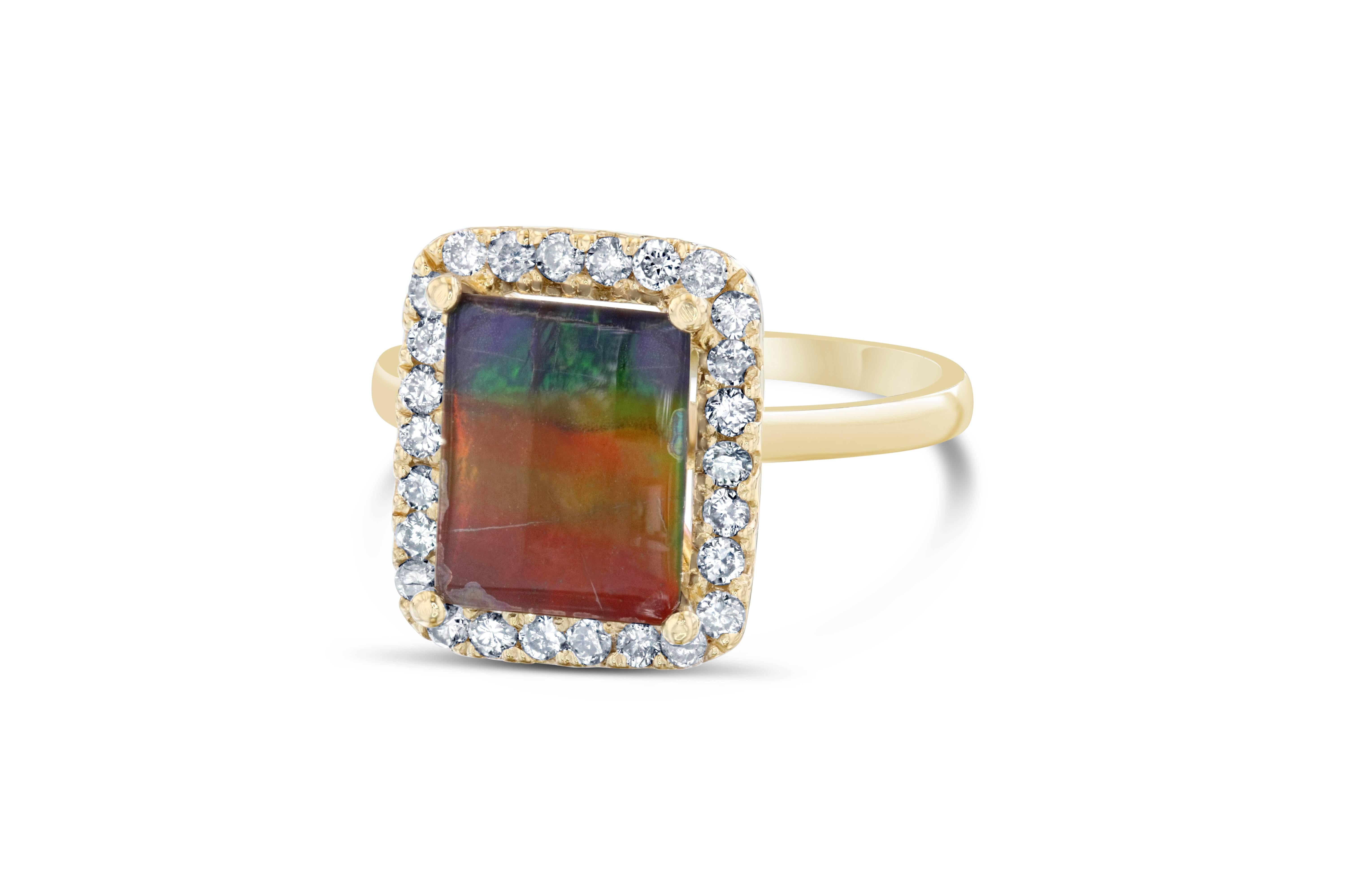 This cute and simple ring has a 1.80 carat Rectangular Cut Ammolite in the center of the ring. Ammolite is an Opal-like organic gemstone that is primarily found in the eastern slopes of the North American Rocky Mountains. The ring also has a halo of