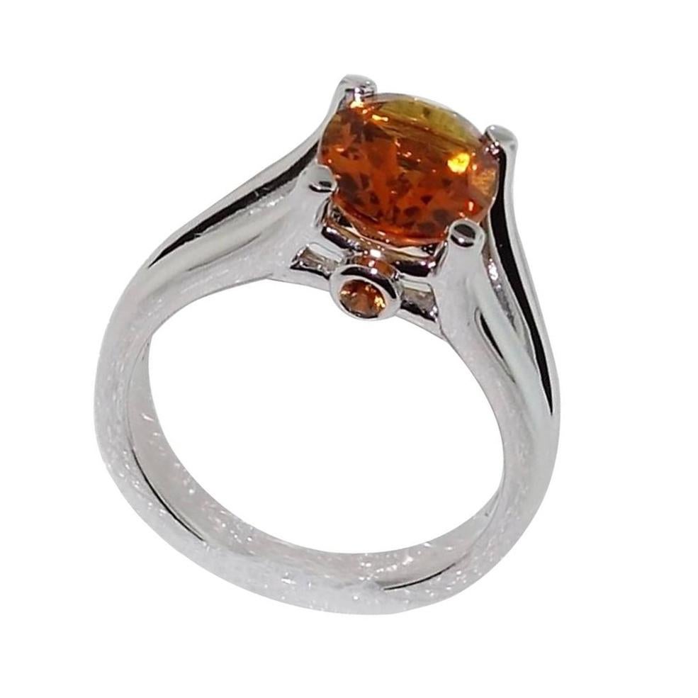 Beautiful ring featuring a 2.24ct Citrine in center enhanced on either side by Sapphires; approx. .08ct. Sterling Silver Rhodium Tarnish-resistant mounting. Size 7; We offer complimentary ring re-sizing. Classic and Classy …illuminating your look