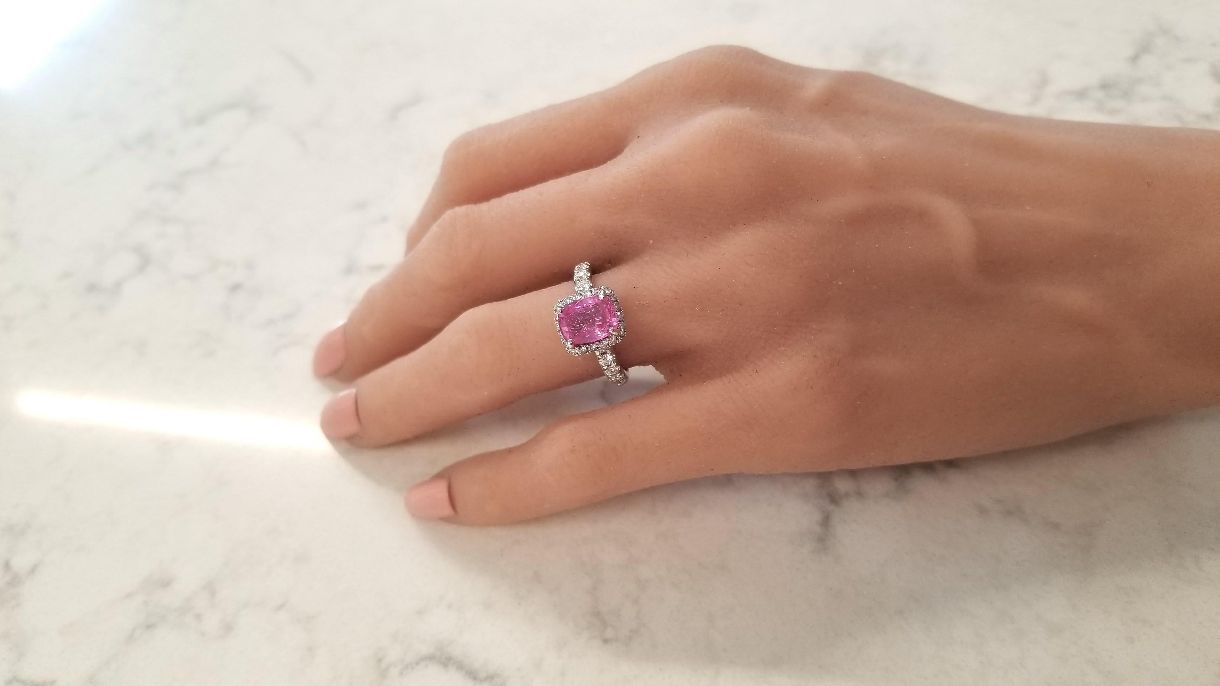 This is a 2.24 carat cushion cut pink sapphire that measures 8.75 x 6.60mm. The intense bubble gum pink sapphire is from Sri Lanka. It's saturation, transparency, and luster are excellent. This gorgeous sapphire is surrounded by 30 prong set round