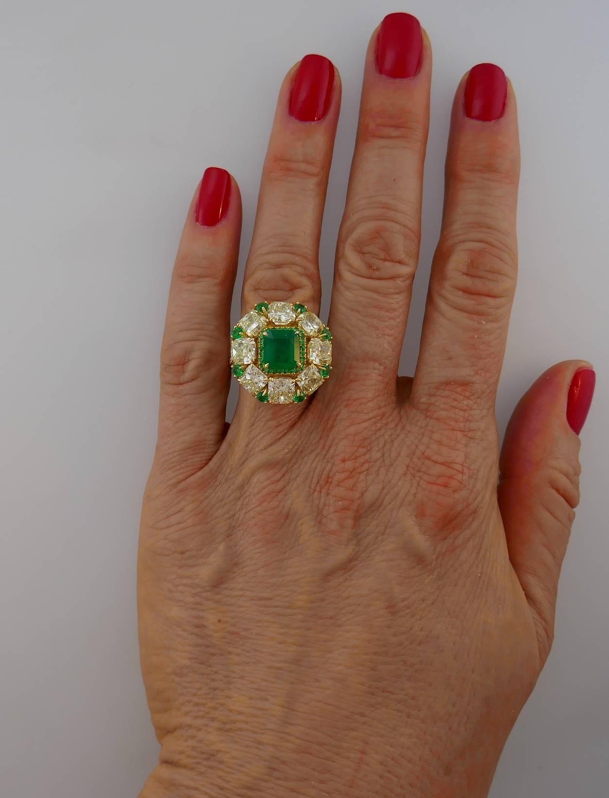 Sparkly and colorful cocktail ring that is a great addition to your jewelry collection.
It is made of 18 karat (stamped) yellow gold and features a gorgeous 2.24-carat finest color emerald framed with a row of eight light fancy yellow radiant cut
