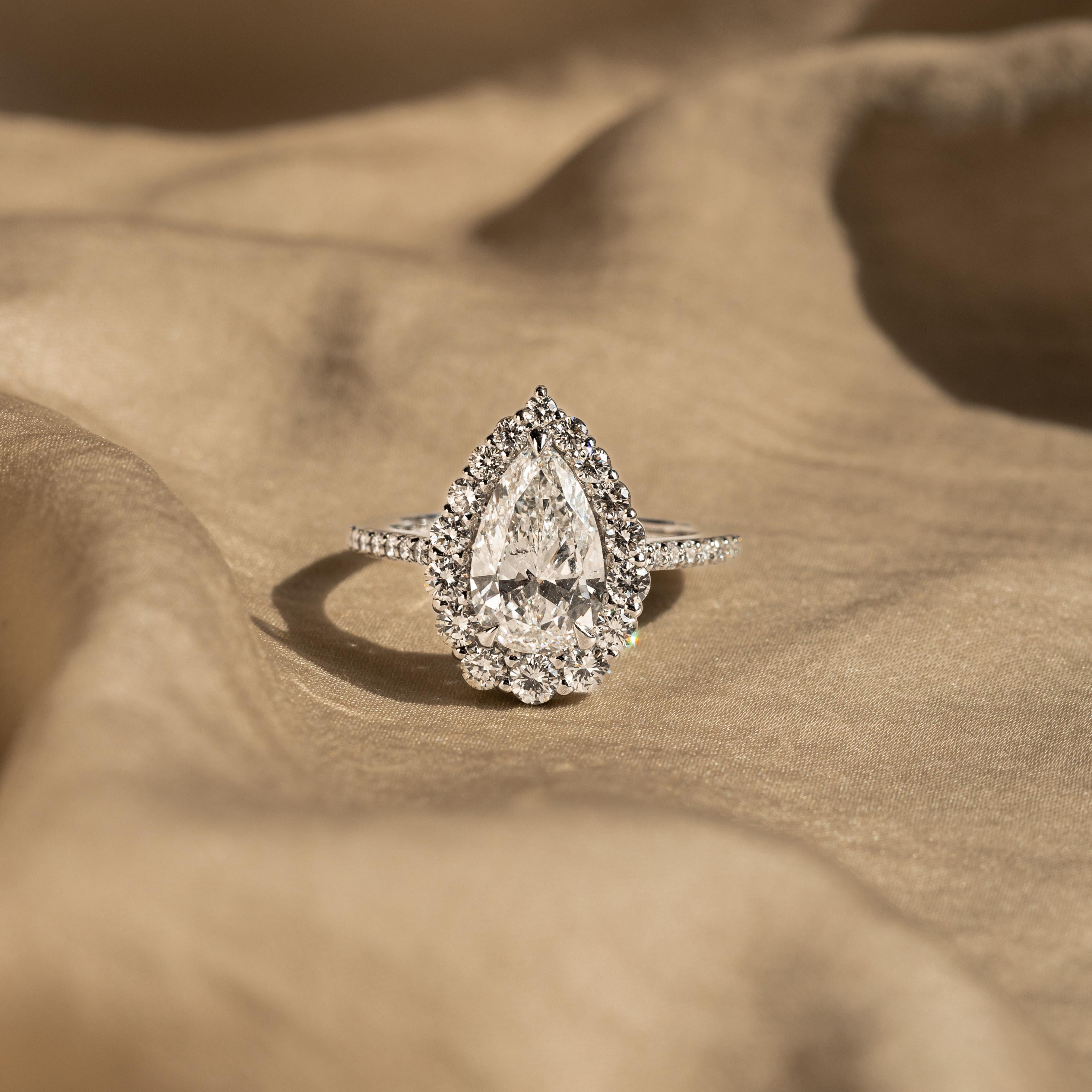 Pear Cut 2.24 Carat Pear Diamond Graduated Halo Engagement Ring For Sale