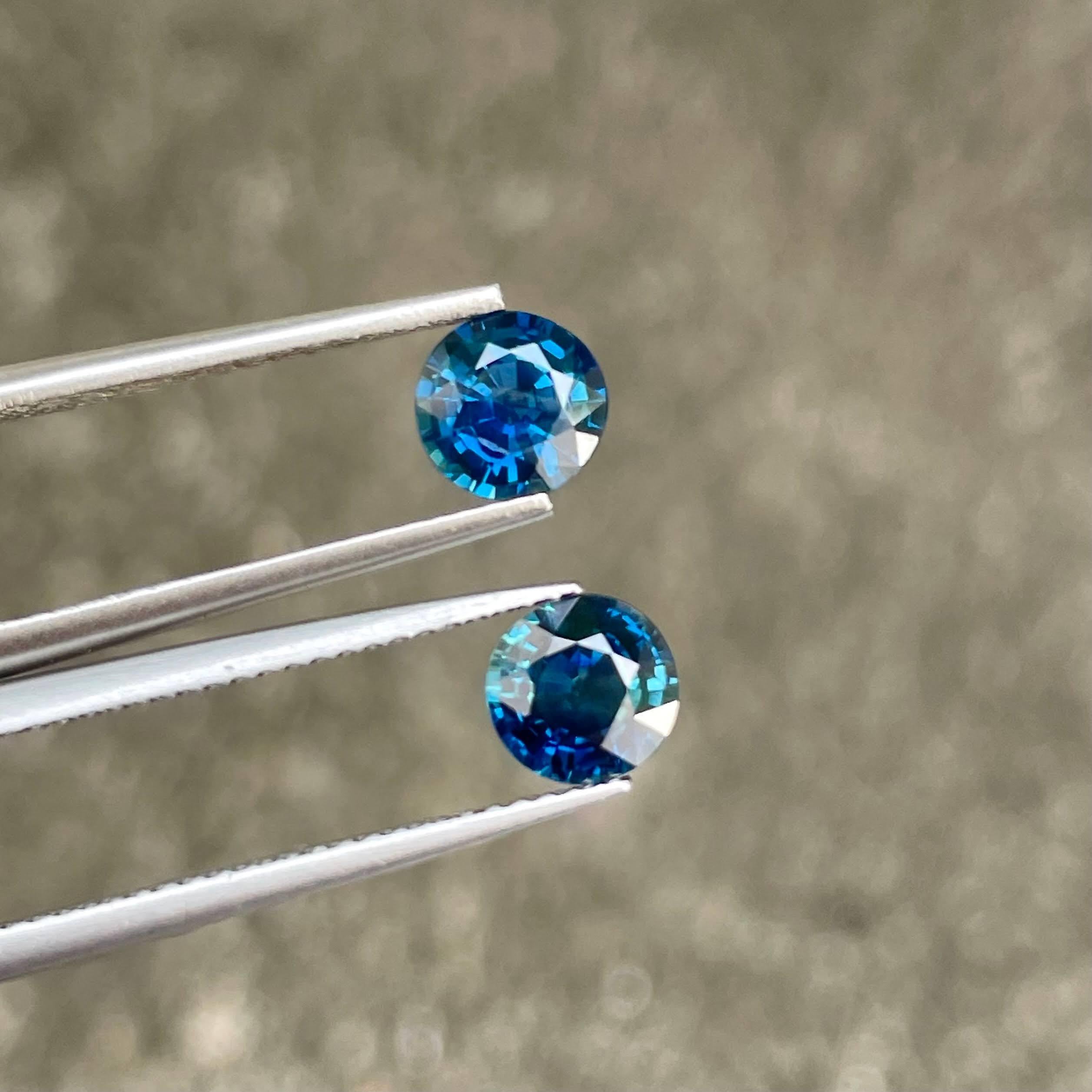Weight 2.24 carats 
Dimensions 6.3x3.5 mm
Treatment Heated 
Origin Madagascar 
Clarity VVS/Better 
Shape round 
Cut round brilliant 





Behold the mesmerizing beauty of a 2.24-carat pair of Teal Blue Sapphires, impeccably crafted in a Round Cut to