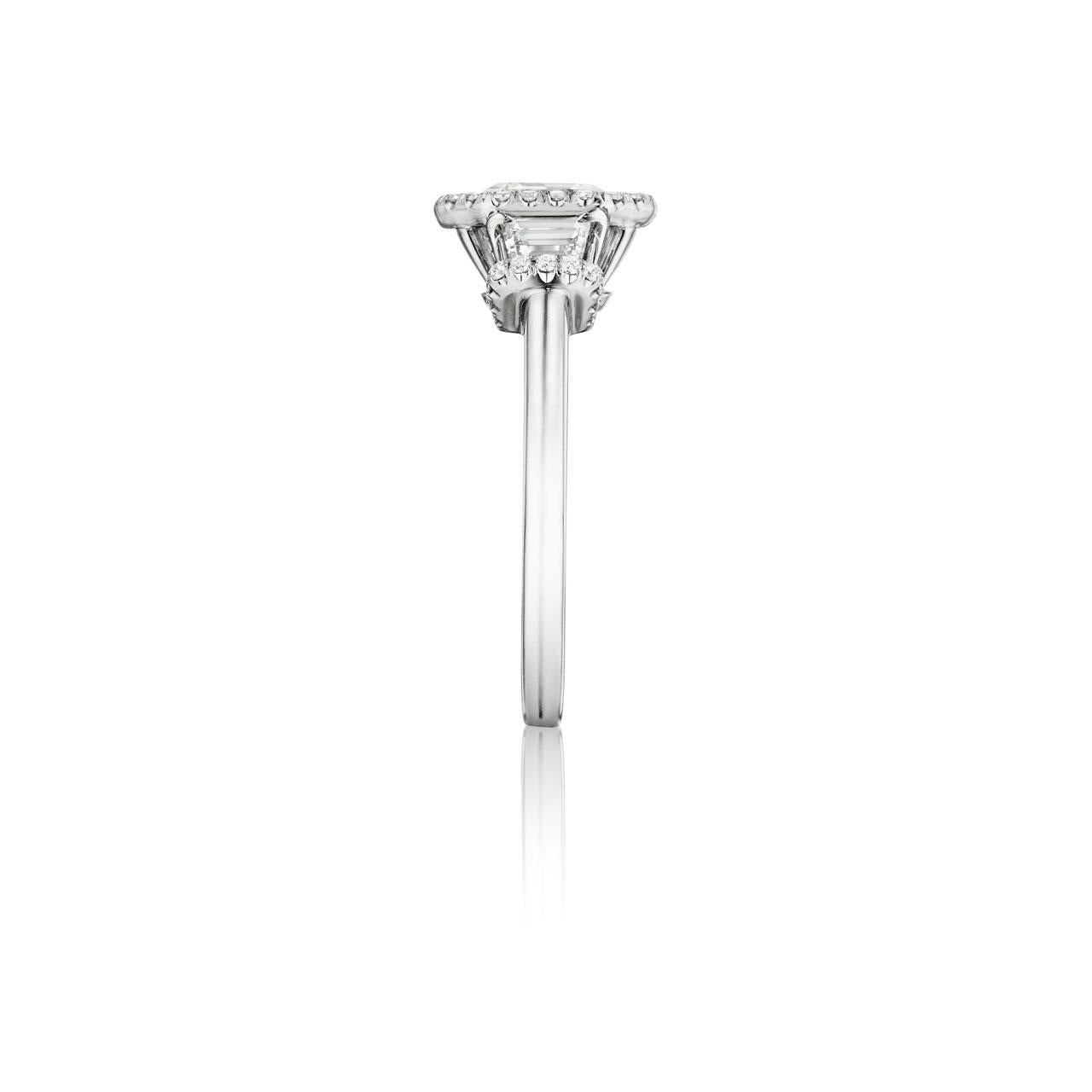 This beautiful 2.24 ct.  G color VS1 clarity GIA certified Asscher Cut Diamond is enriched by two trapezoid diamonds  and micro paved small diamond melee all G color and VS quality weighing .60ct. total weight. It is currently a size 6.5 but we will