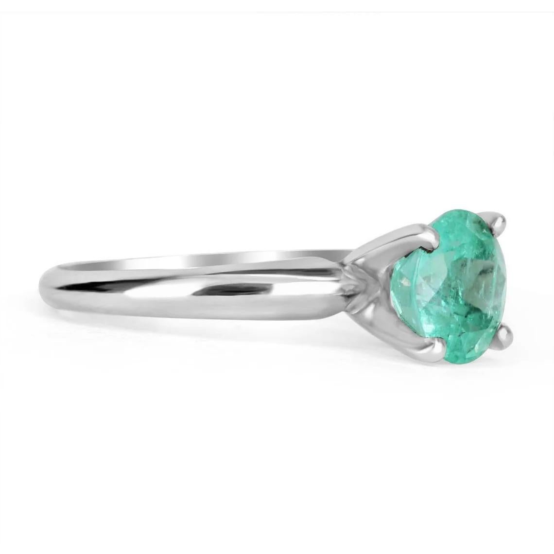 Displayed is a classic Colombian emerald solitaire, round-cut, timeless engagement ring in solid 14K gold. This gorgeous solitaire ring carries a full 2.24-carat emerald in a four-prong setting. Fully faceted, this gemstone showcases excellent shine