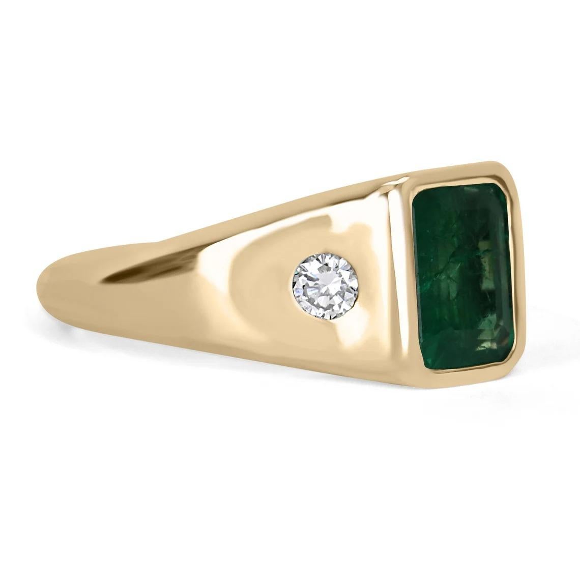 Displayed is a classic modern dark green emerald & round diamond three-stone men's unisex ring in 14K yellow gold. This unique solitaire ring carries an emerald in a secure hand bezel setting giving it extra protection and shine. Fully faceted, this