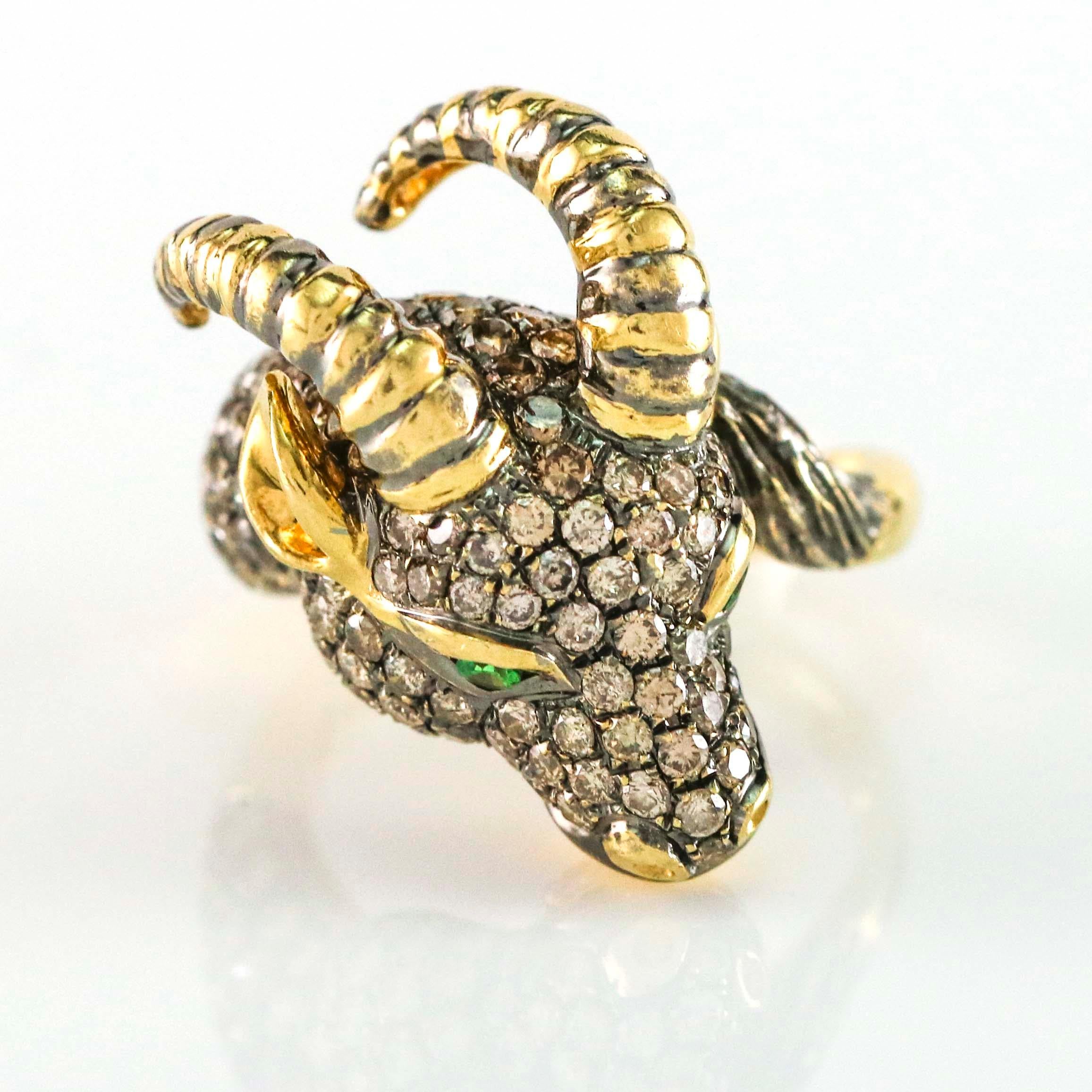 Goats head cocktail ring crafted in 18k yellow gold encrusted with champagne diamonds. Emerald eyes. Size 7.5. Fashion statement piece. 