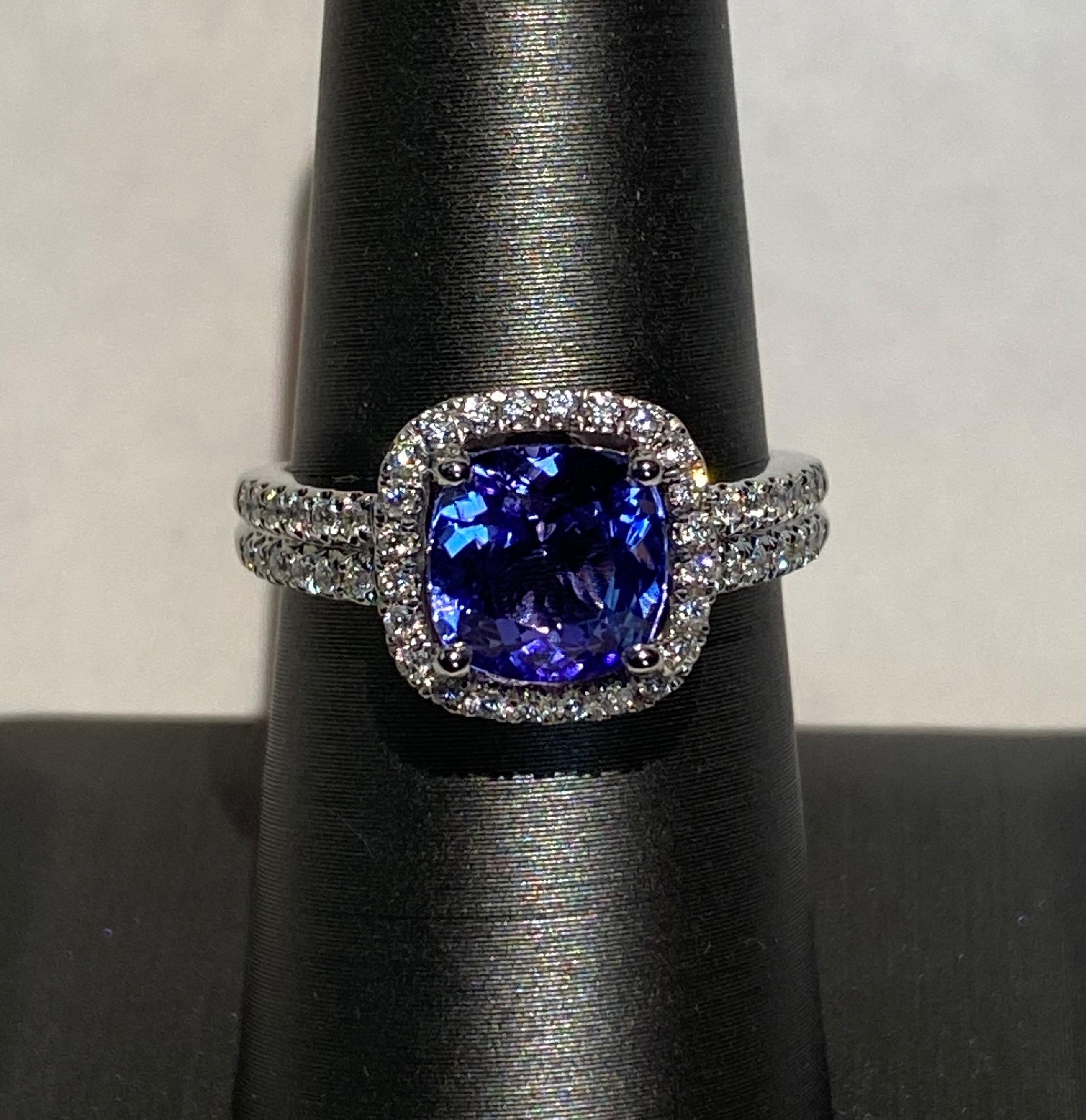 Cushion cut tanzanite is surrounded by halo of white diamond. It has a band of double row pave set diamond. Crafted with skilled hands and set in white gold. Very elegant.
Tanzanite: 2.25ct
White Diamond: 0.33ct
White Gold: 14K
Size: 7 (resizeable)