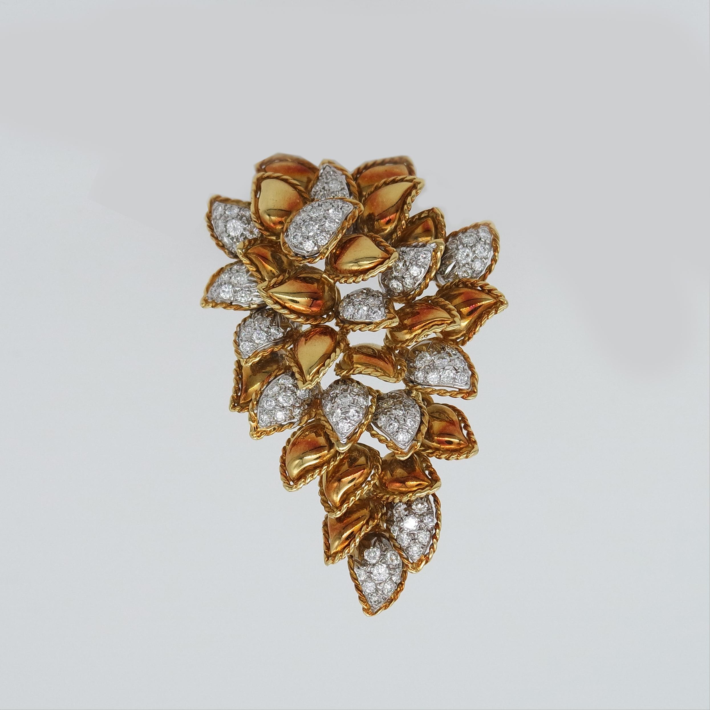 This vintage brooch in 18 karat yellow gold with round brilliant diamonds exudes Milanese elegance from re-known Via Montenapoleone jeweler Sabbadini. 
It is constructed with 31 small gold leaves of which some with diamonds, assembled on
