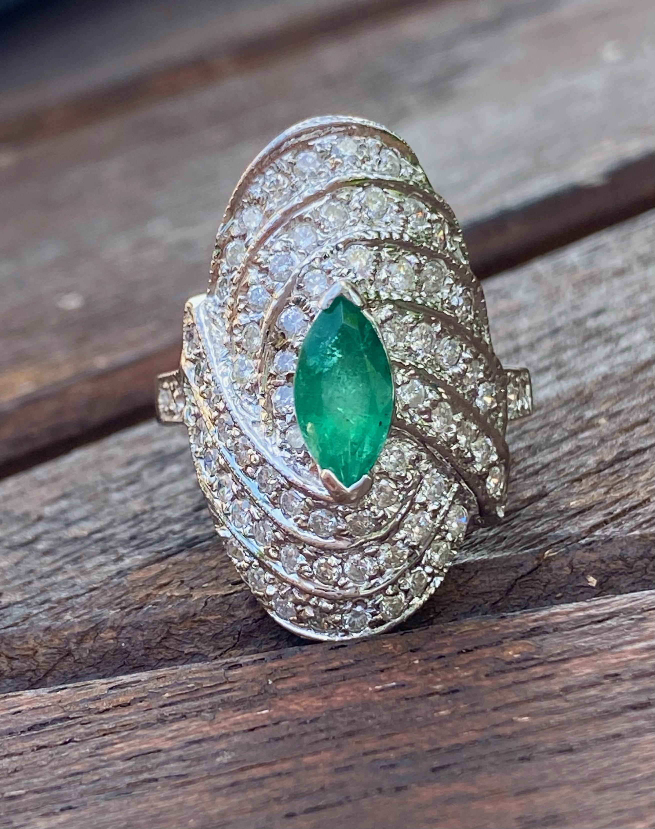 Centering a 0.75 Carat Marquis-Cut Colombian Emerald, framed by an additional 1.50 Carats of Round-Brilliant Cut Diamonds, and set in 14K White Gold, this vintage ring is a symmetrical treasure. 

Details:
✔ Stone: Emerald
✔ Center-Stone Weight: