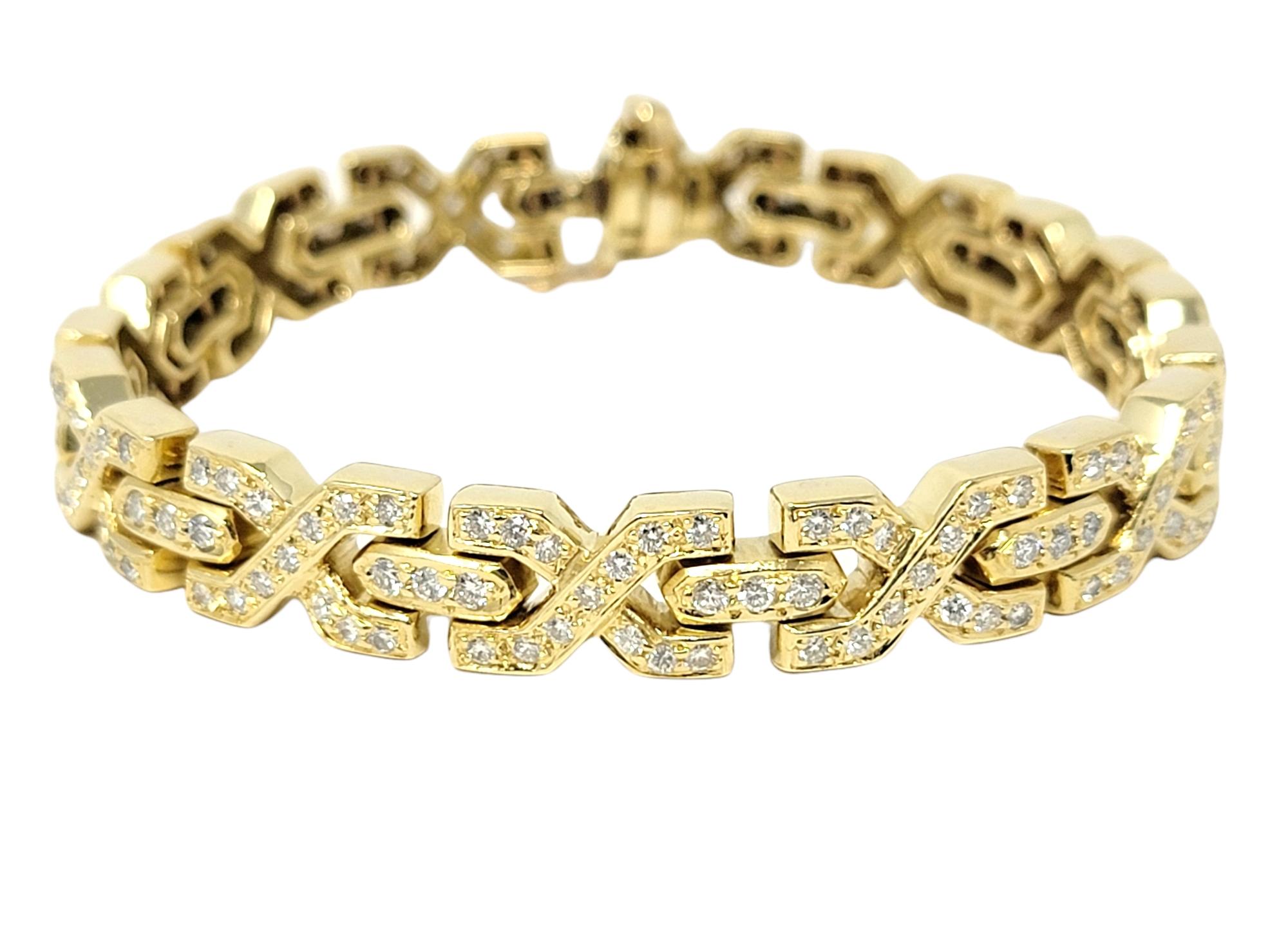 This beautiful diamond link bracelet sparkles with glamour and elegance. This sleek, shimmering piece features diamond embellished 18 karat yellow gold 'X' links set in a single row. The glittering diamonds sparkle beautifully from all angles,