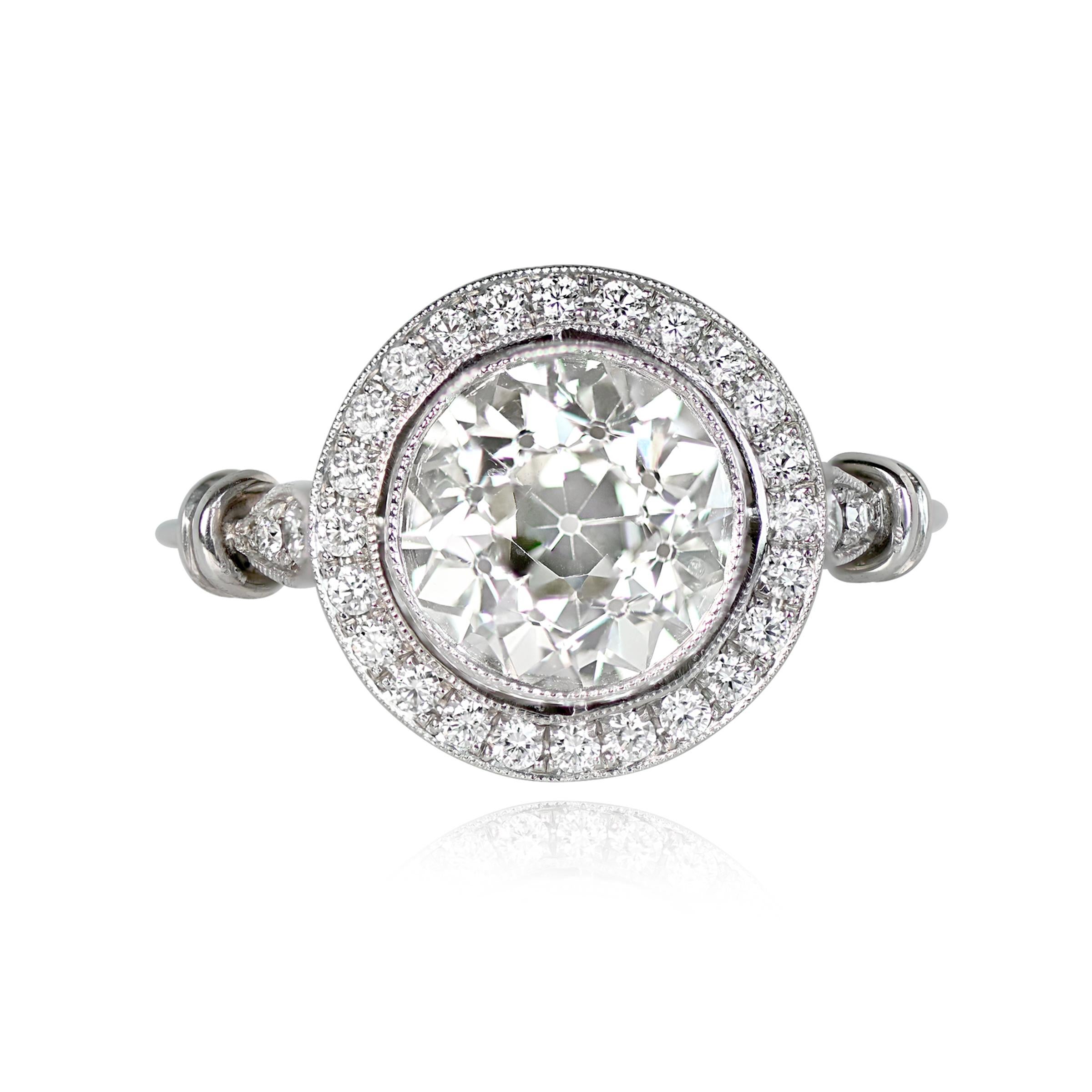 Halo engagement ring with a 2.25 carat old European cut diamond in L color and VS1 clarity. The center diamond is bezel set and surrounded by pave-set round brilliant cut diamonds. Marquise-shaped bezels with round brilliant diamonds are on each
