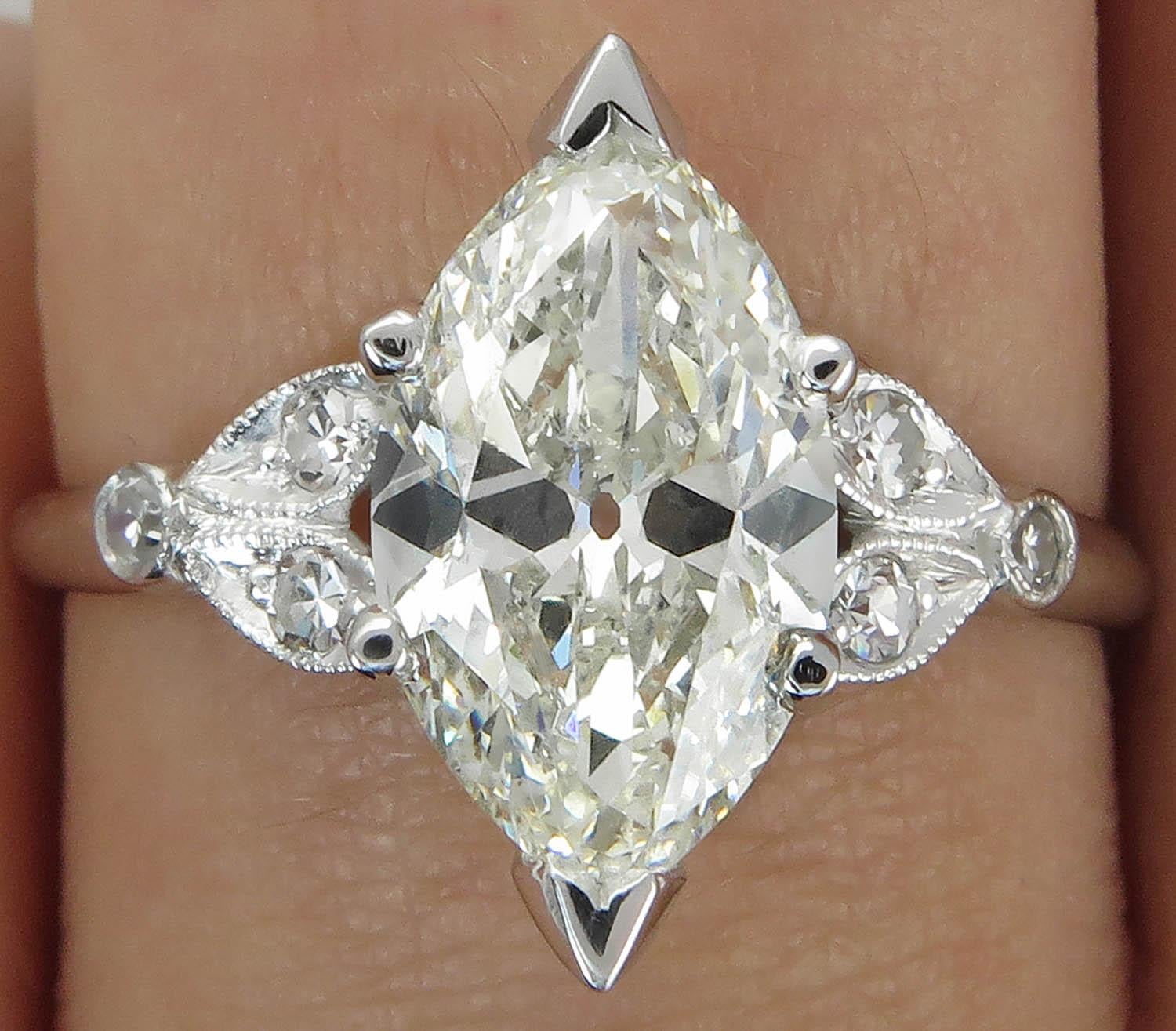 A Timeless Elegant Authentic Art Deco CIRCA 1930s Engagement Ring with EGL USA Certified 2.09ct Old European Marquise Center Diamond in J-K color SI2 clarity (Eye Clean).
It is set into Gorgeous Unique Mounting Platinum (stamped) and accented with 6