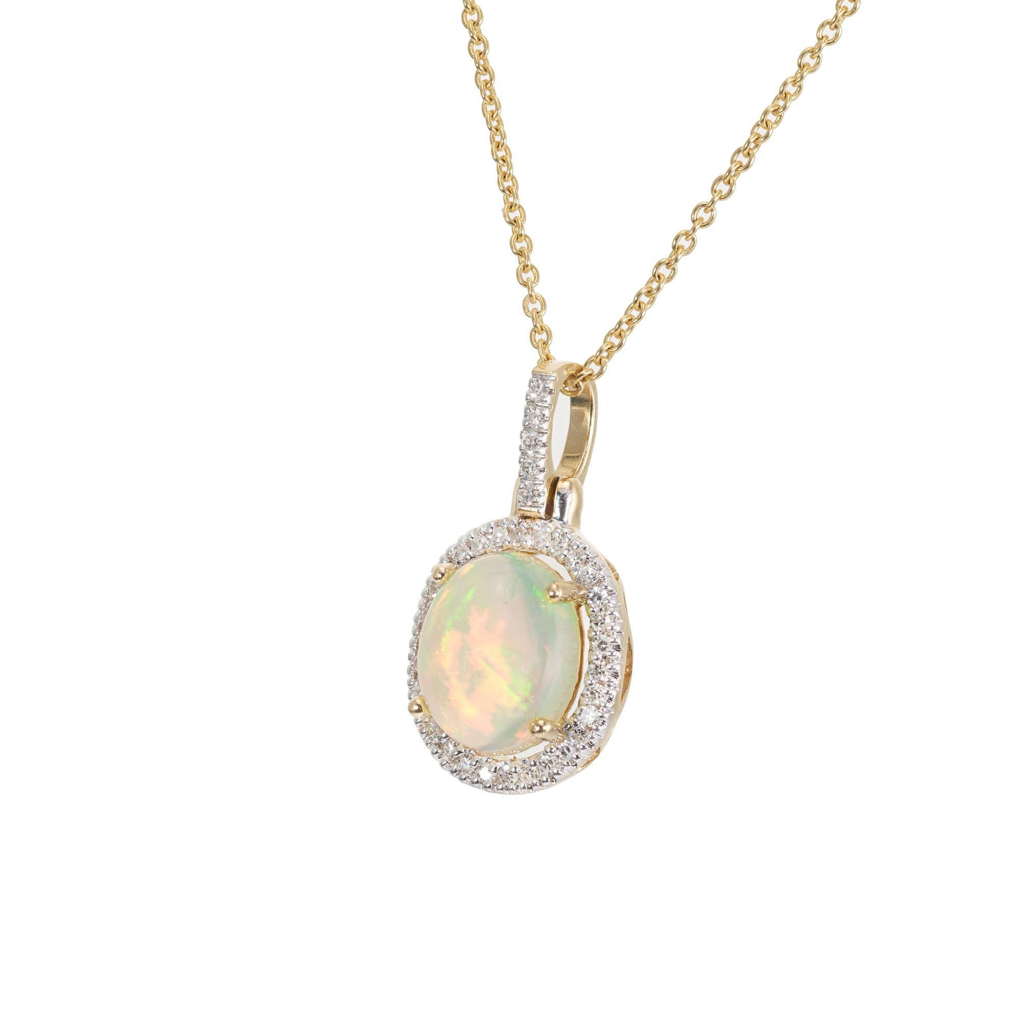 Opal and diamond pendant necklace. 2.25 oval opal with a halo of 35 single cut diamonds, in 14k yellow gold setting and 16 inch chain. 

1 oval reddish green pendant, approx. 2.25cts
35 single cut diamonds, G-H SI approx. .18cts
14k yellow gold