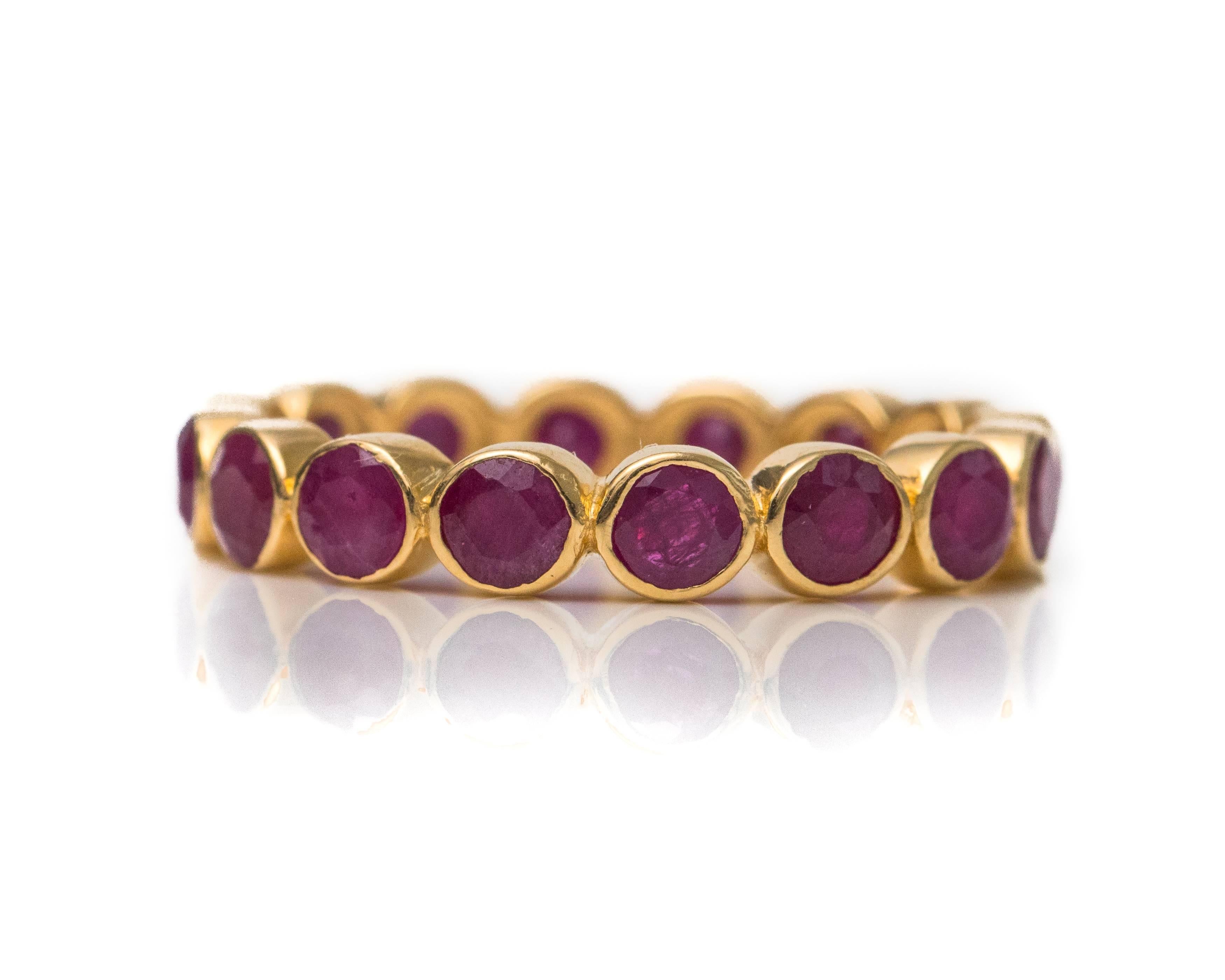 2.5 Carat Ruby and 18 Karat Yellow Gold Eternity Band

Features a ring of Red Rubies in 18 Karat Yellow Gold. The Round Brilliant Red Ruby gemstones are bezel set in rich 18 Karat Yellow Gold. The sides of the ring have a smooth, high polish finish.