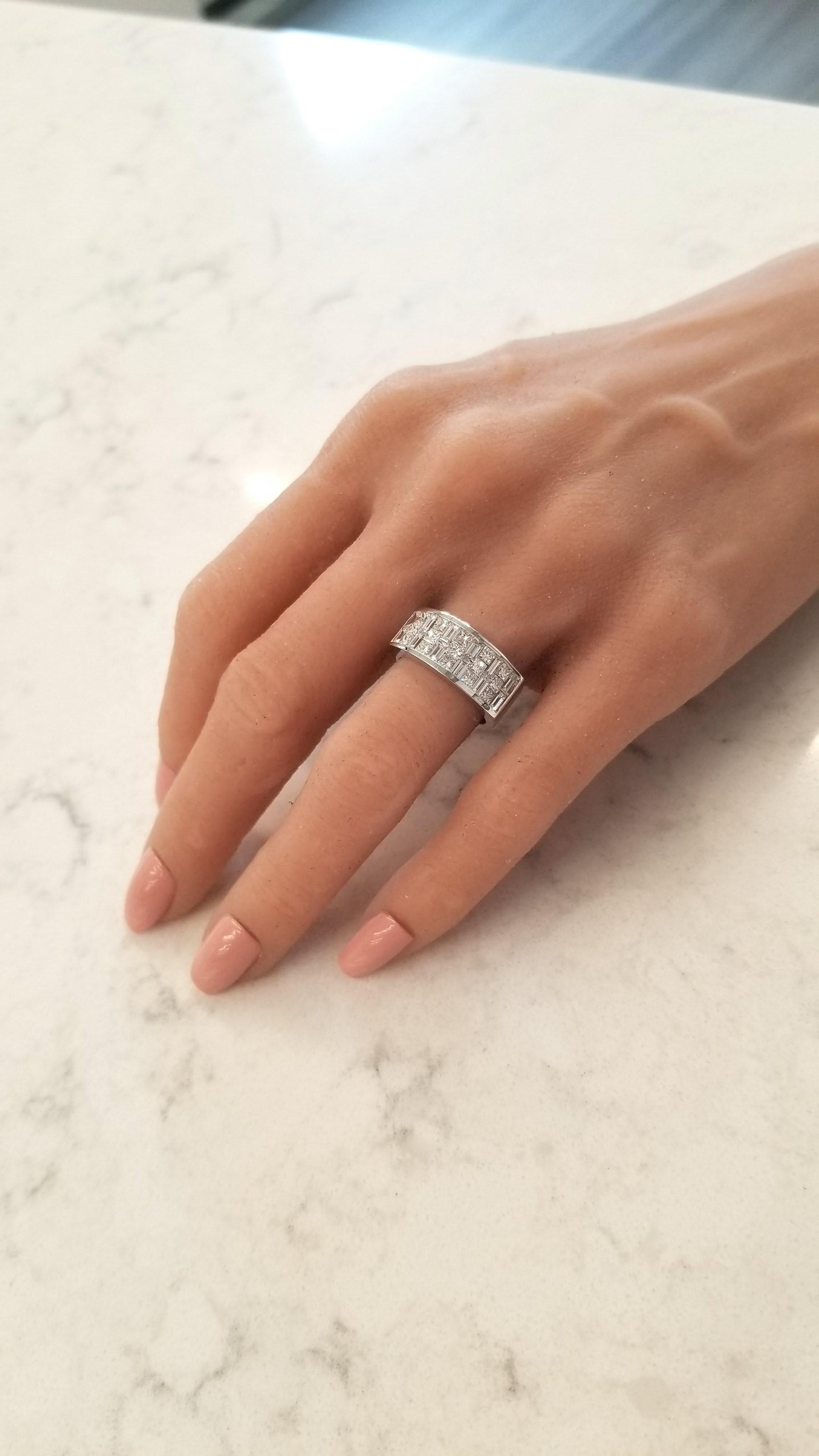 Expertly invisibly channel-set diamonds adorn this striking three-quarter eternity band, alternating between princess cut and shimmering baguette cut, arranged in a spectacular basket grid repeating pattern totaling 2.05 carats. Created in brightly